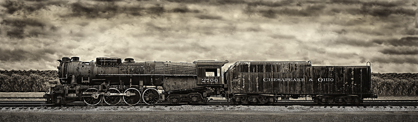 A sepia colored photograph of a train with the words "Chesapeake & Ohio" and "2700" painted on the sides