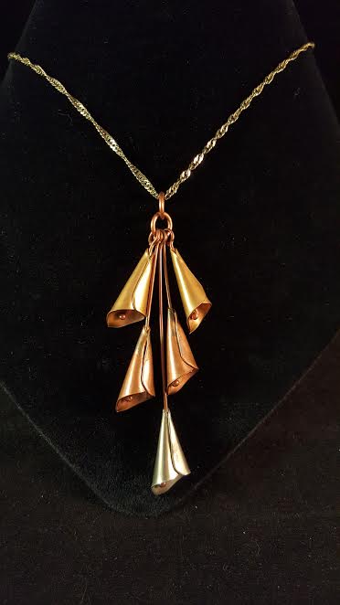 A gold necklace with long flower petals as the decorative