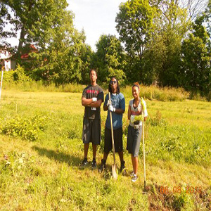 Group members posing with shovels during Summer Program 2012