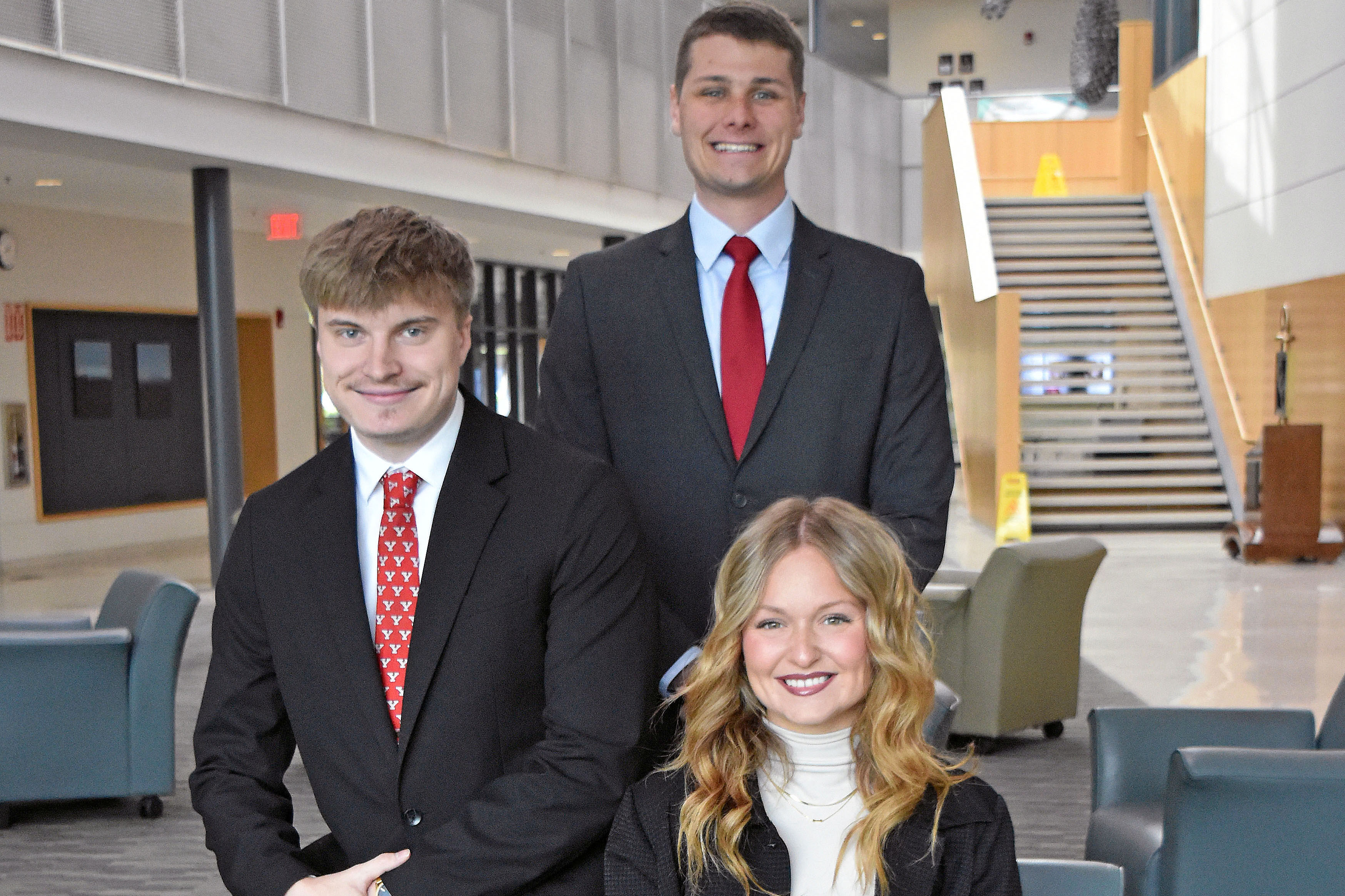 Beeghly Fellows, Aidan Gray, Nathan Heinley, and Kodi Kinsey sitting in the Atrium of Williamson Hall