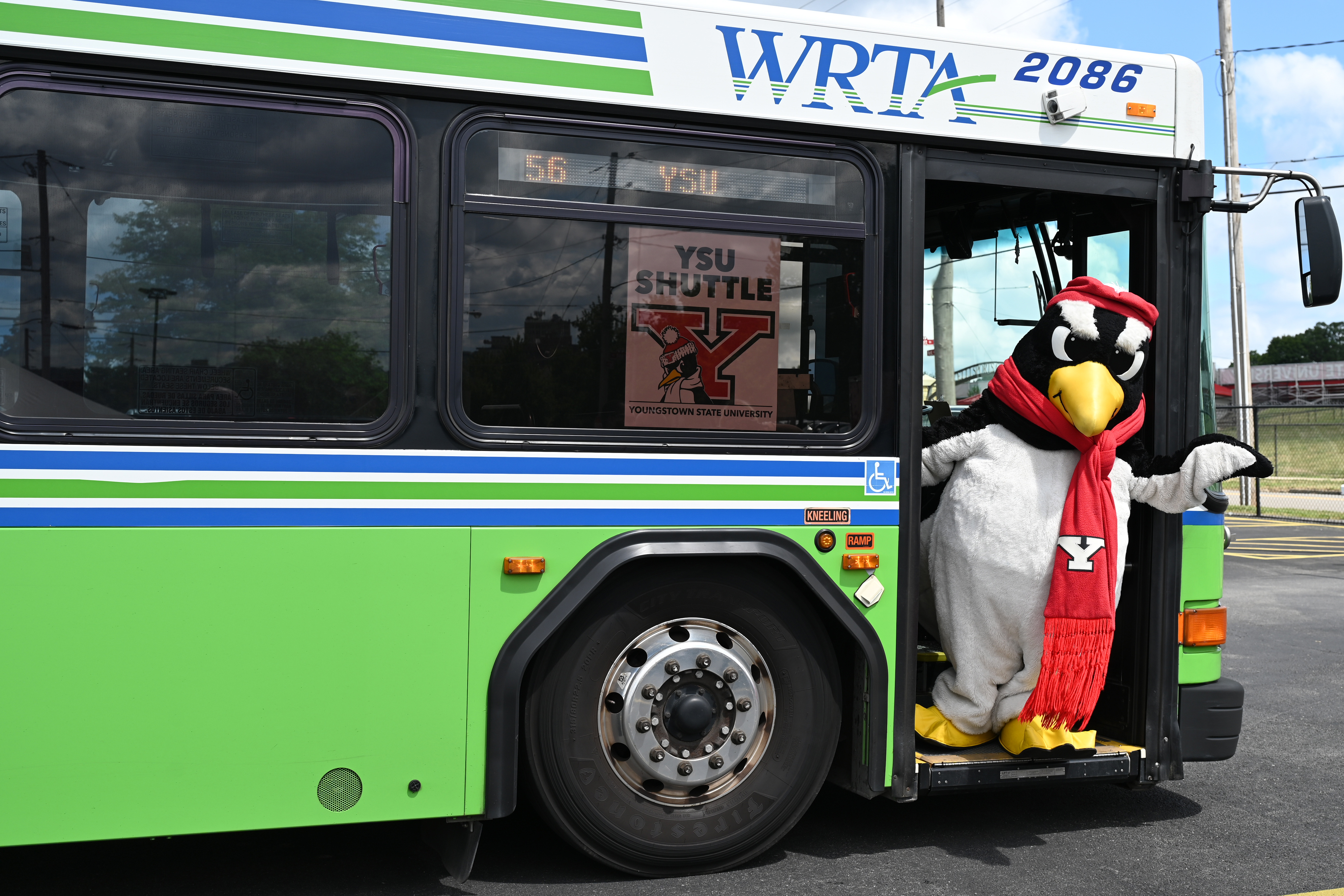 YSU's mascot, Pete the Penguin waving in the doorway of a WRTA bus