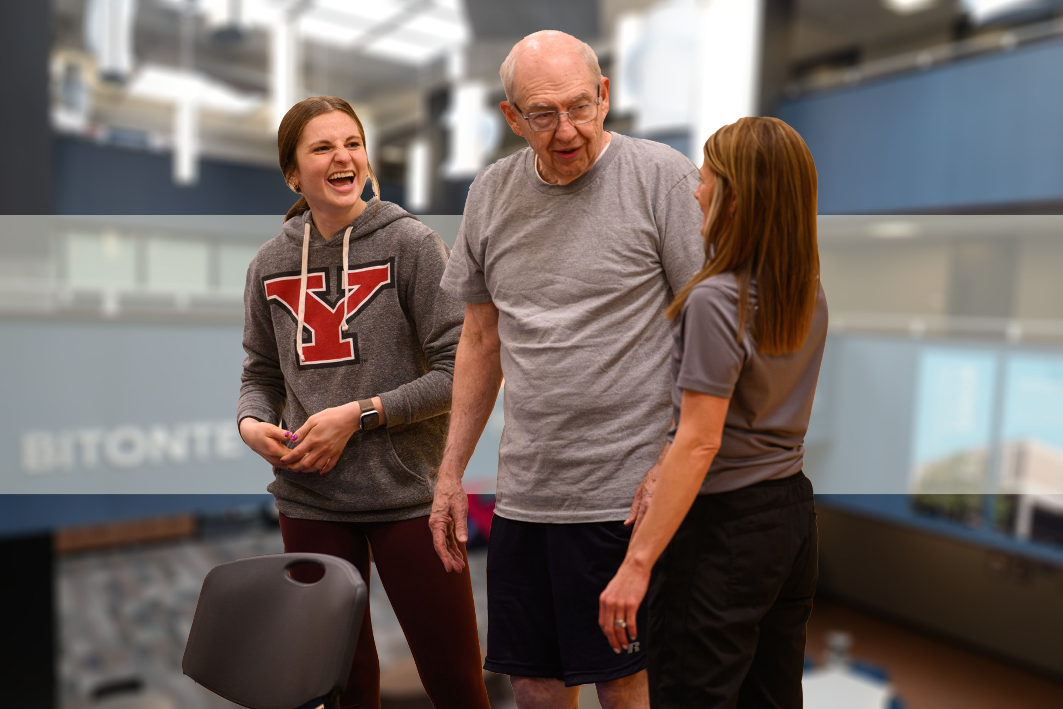 Two students working with a community member in the Fall Prevention Class