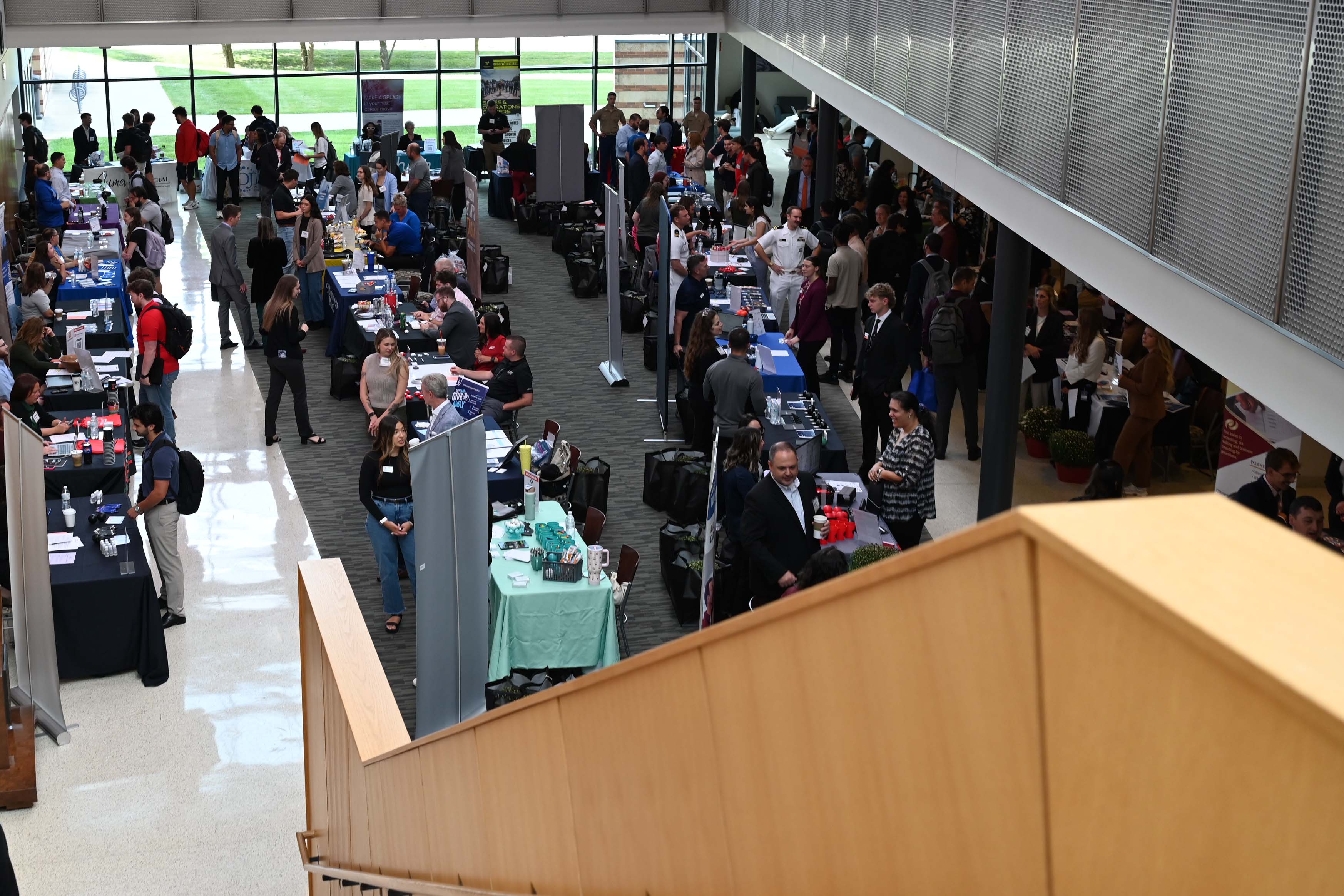 Photo of the Atrium in Williamson Hall, filled with students meeting with employers
