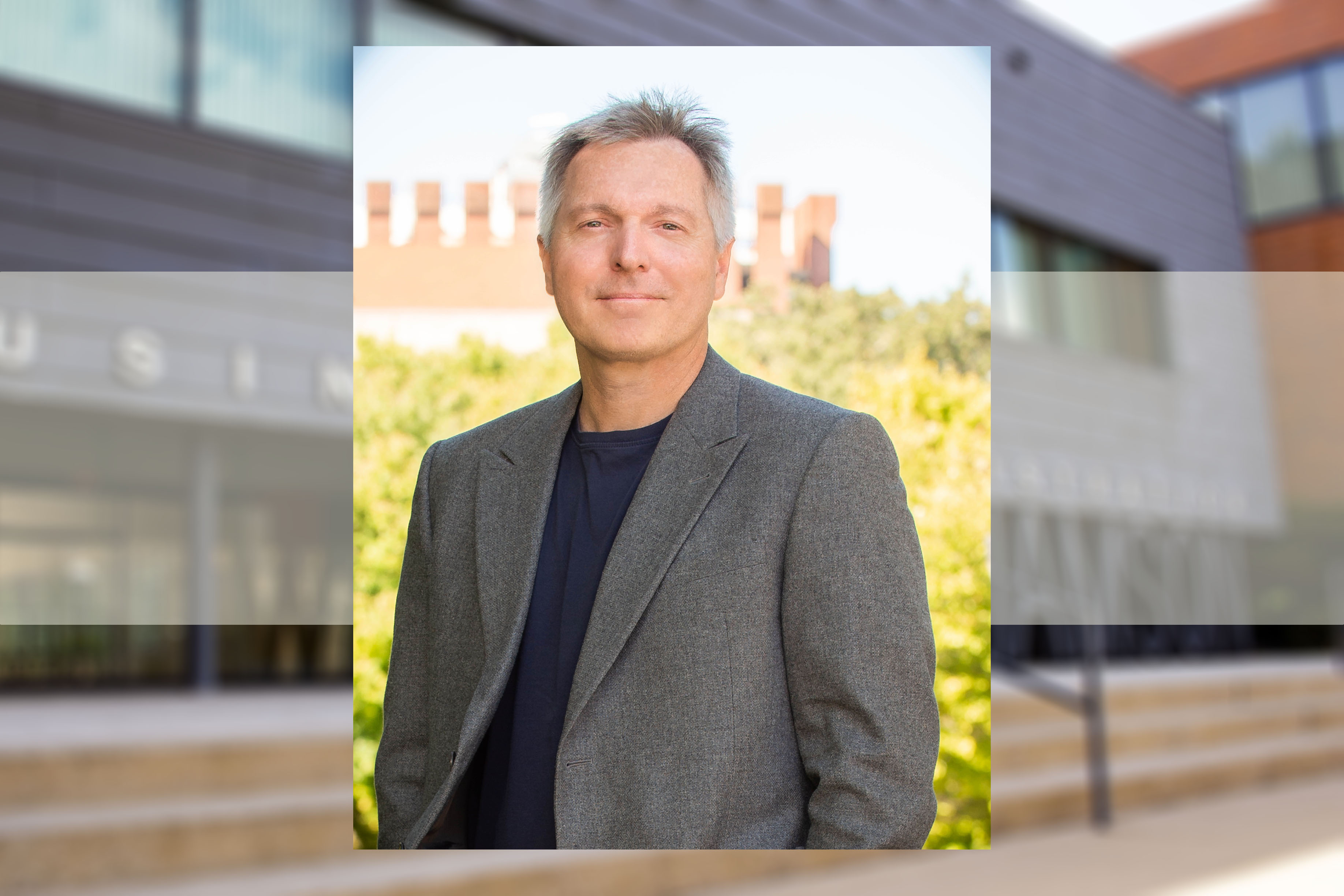 Headshot of John List with a screen of Williamson Hall in the background