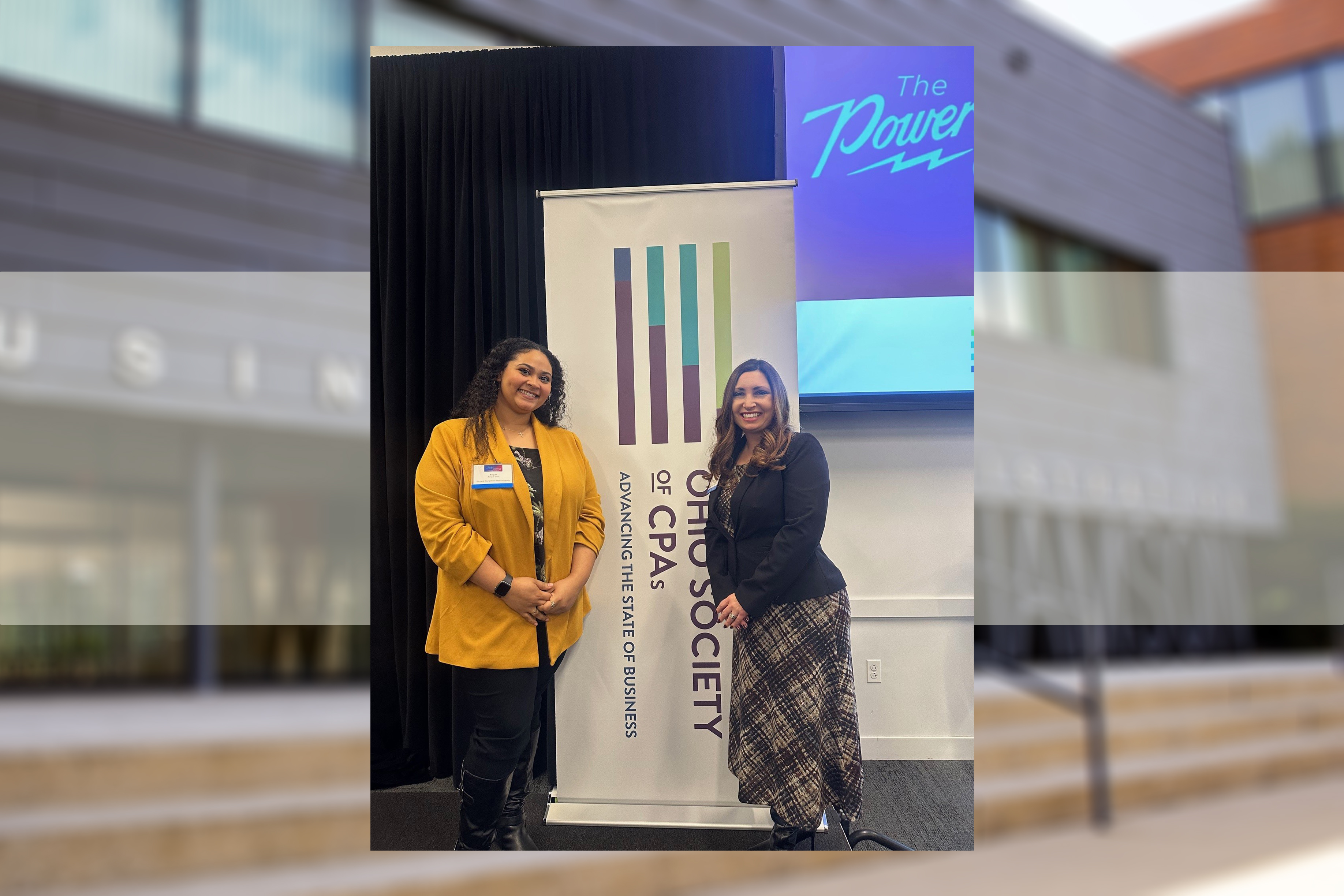 Raquel K. Diaz-McClendon and Jessie Wright pose in front of a banner for the Ohio Society of CPAs