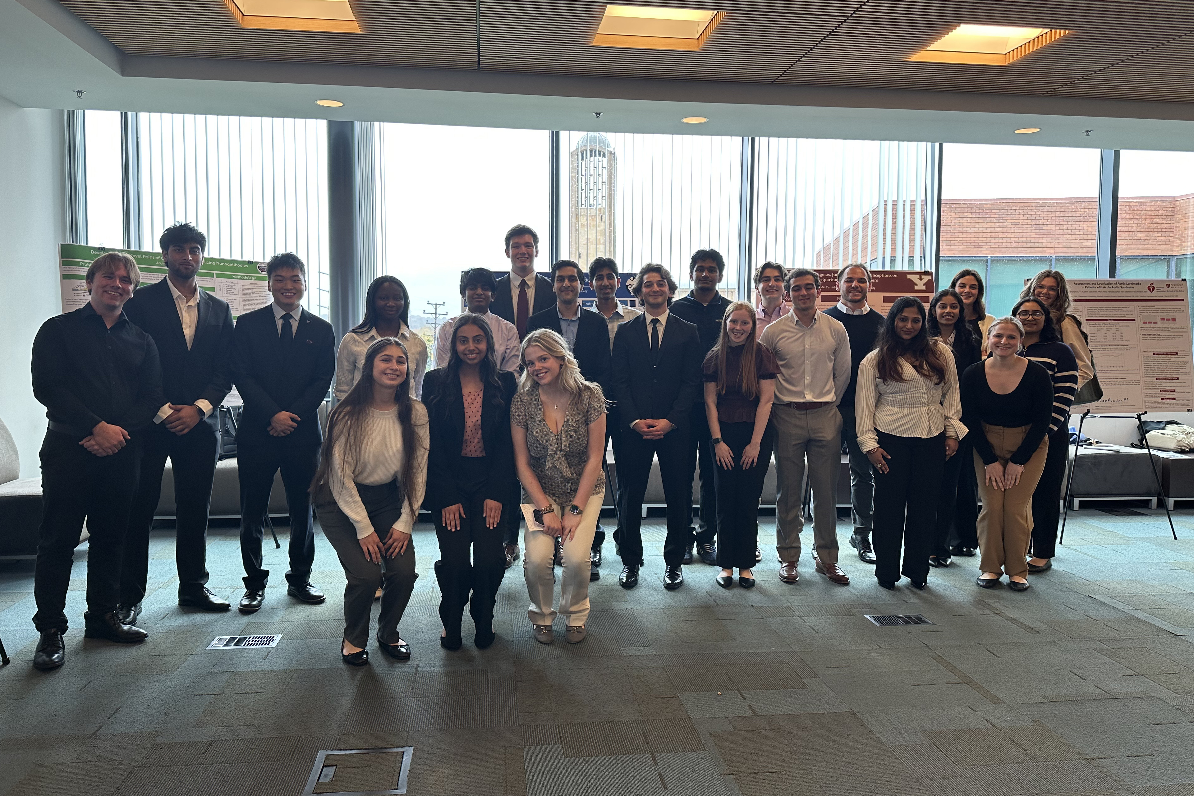 Poster presenters gathering around after the conclusion of the symposium 