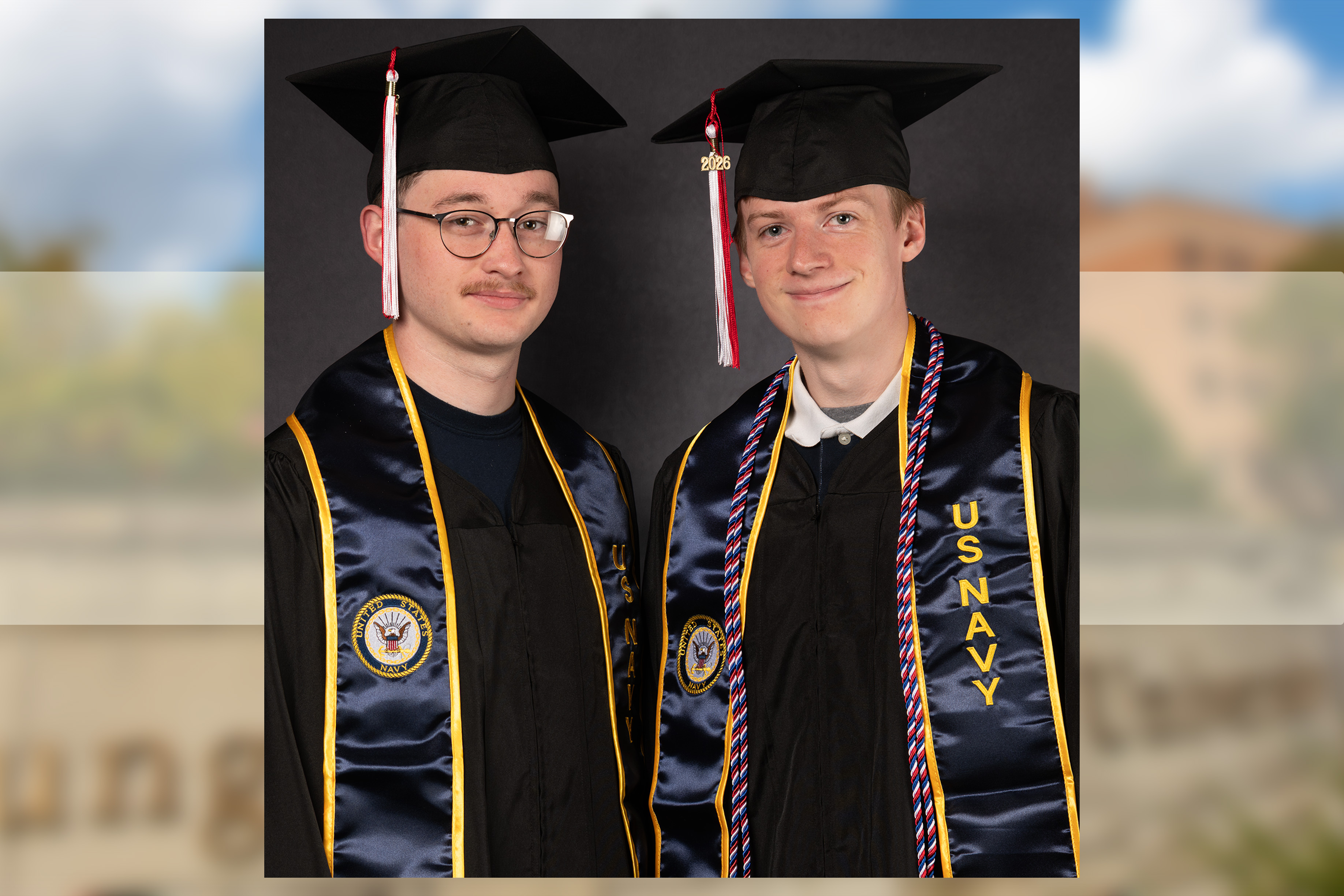 Zane Perrico and Karsten Grenzig in caps and gowns with their Navy stoals