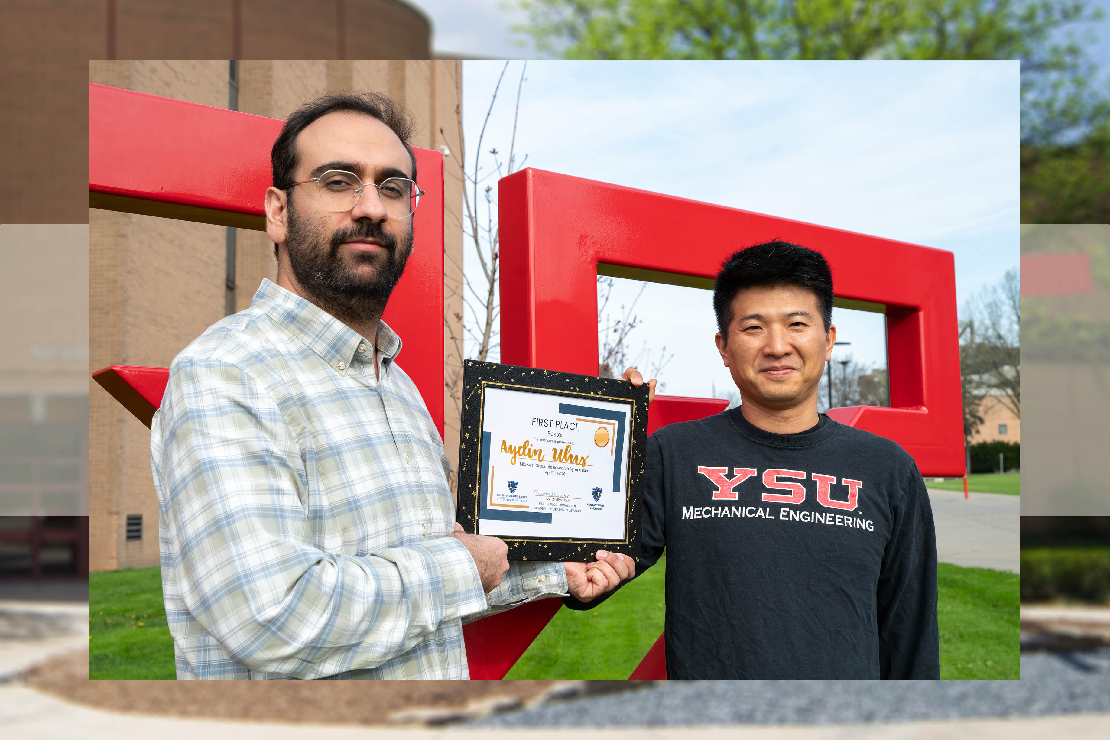Aydin Ulus and Kyosung Choo pose on the YSU campus with Ulus's first place certificate