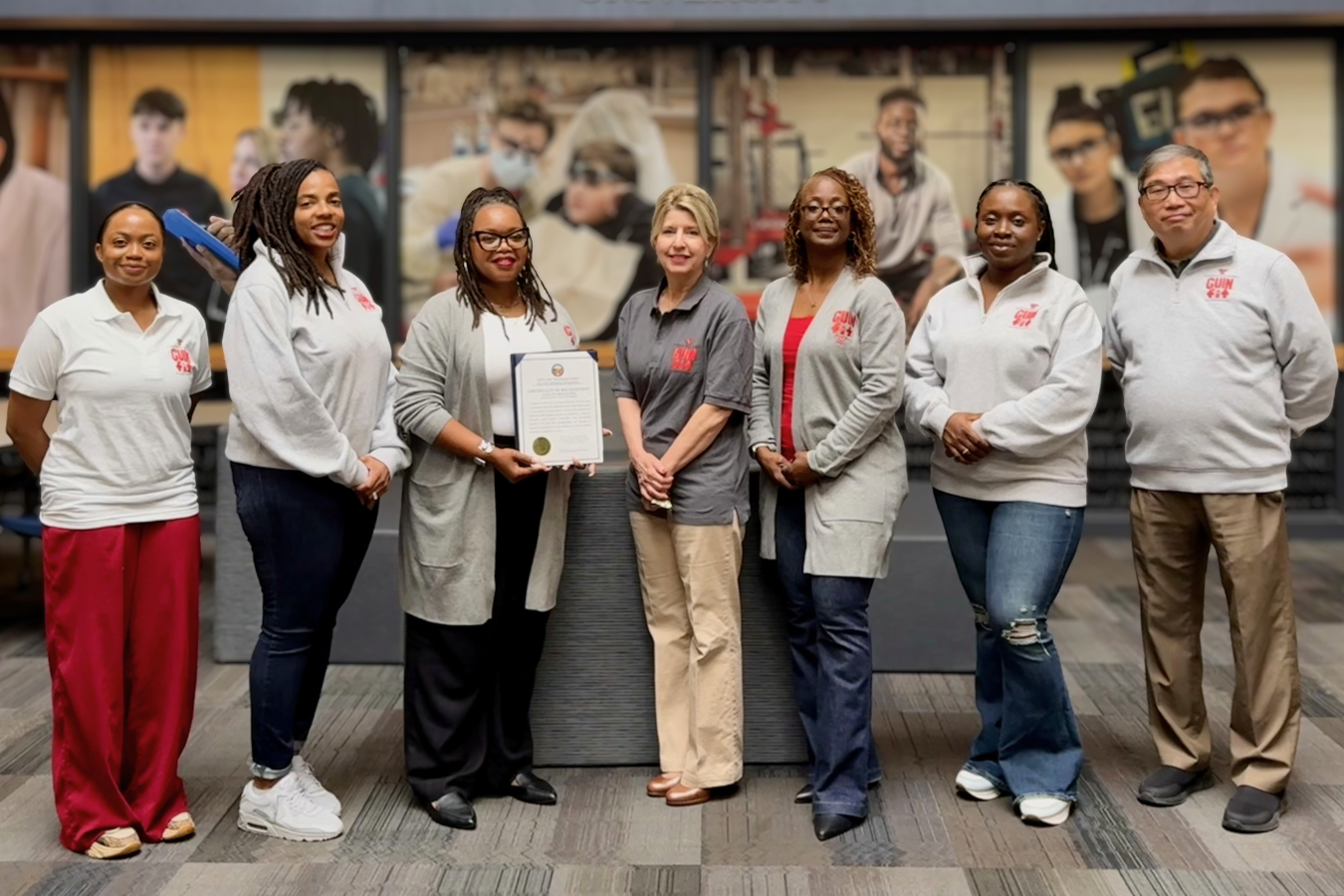 Guin Fit staff pose with the certificate from the city of Youngstown