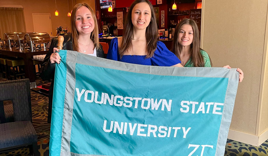 3 members with zta chapter flag