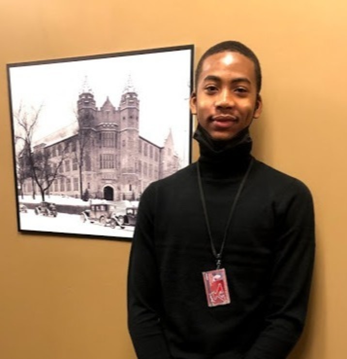 Photo of David Hughley III in front of an old photo of Jones Hall