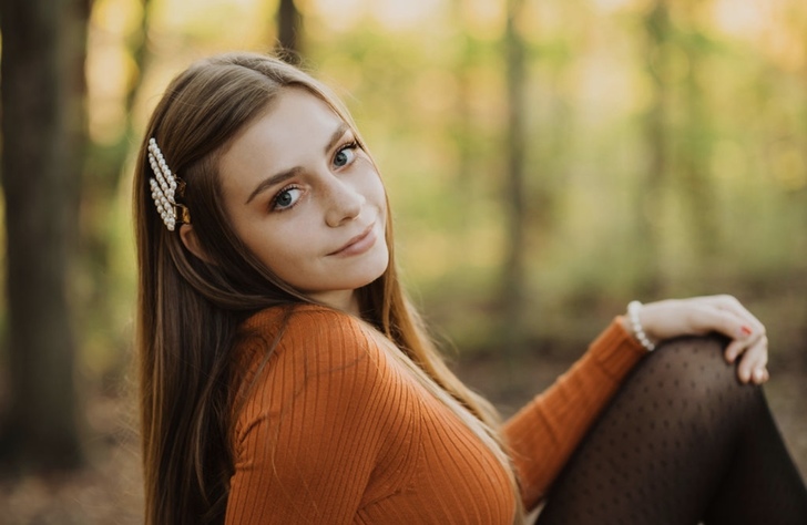 Photo of Julianna Sandine in front of a blurred out forest