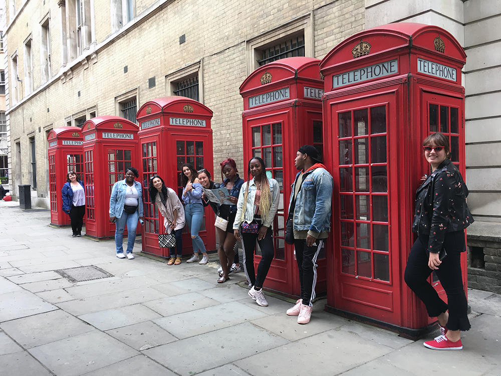 ysu fashion students posing for photo in front of red classic phone booths in london