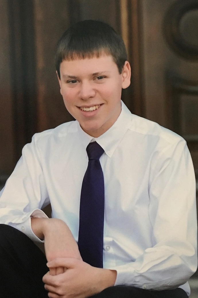 Photo of Mark DeAngelis in front of a dark brown wooden door