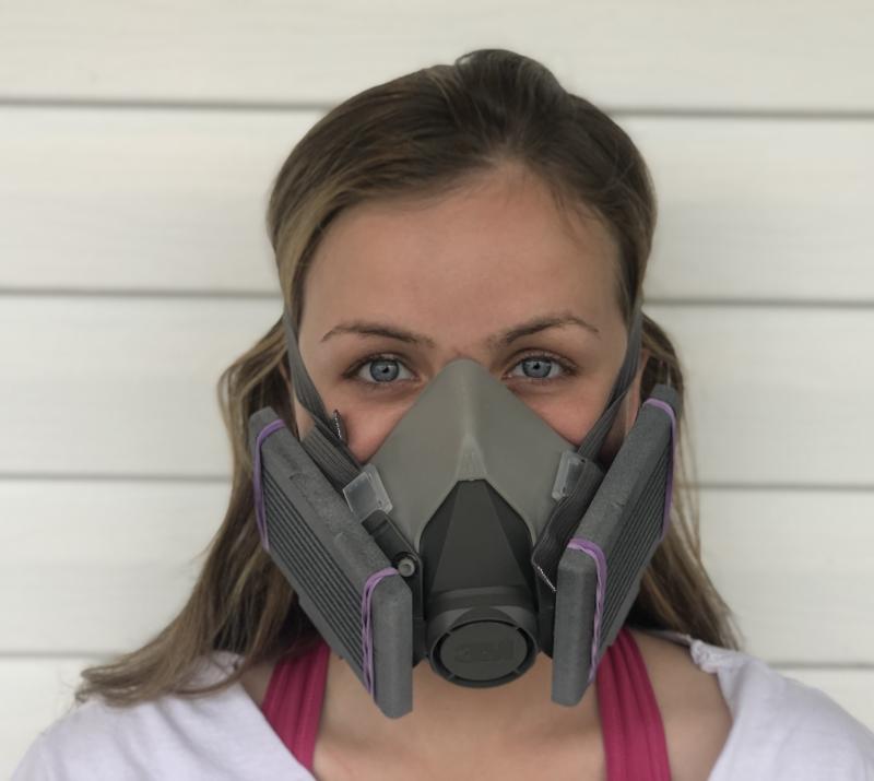 Woman with a commercial facemask equipped with 3D-printed filter cartridges designed by YSU faculty