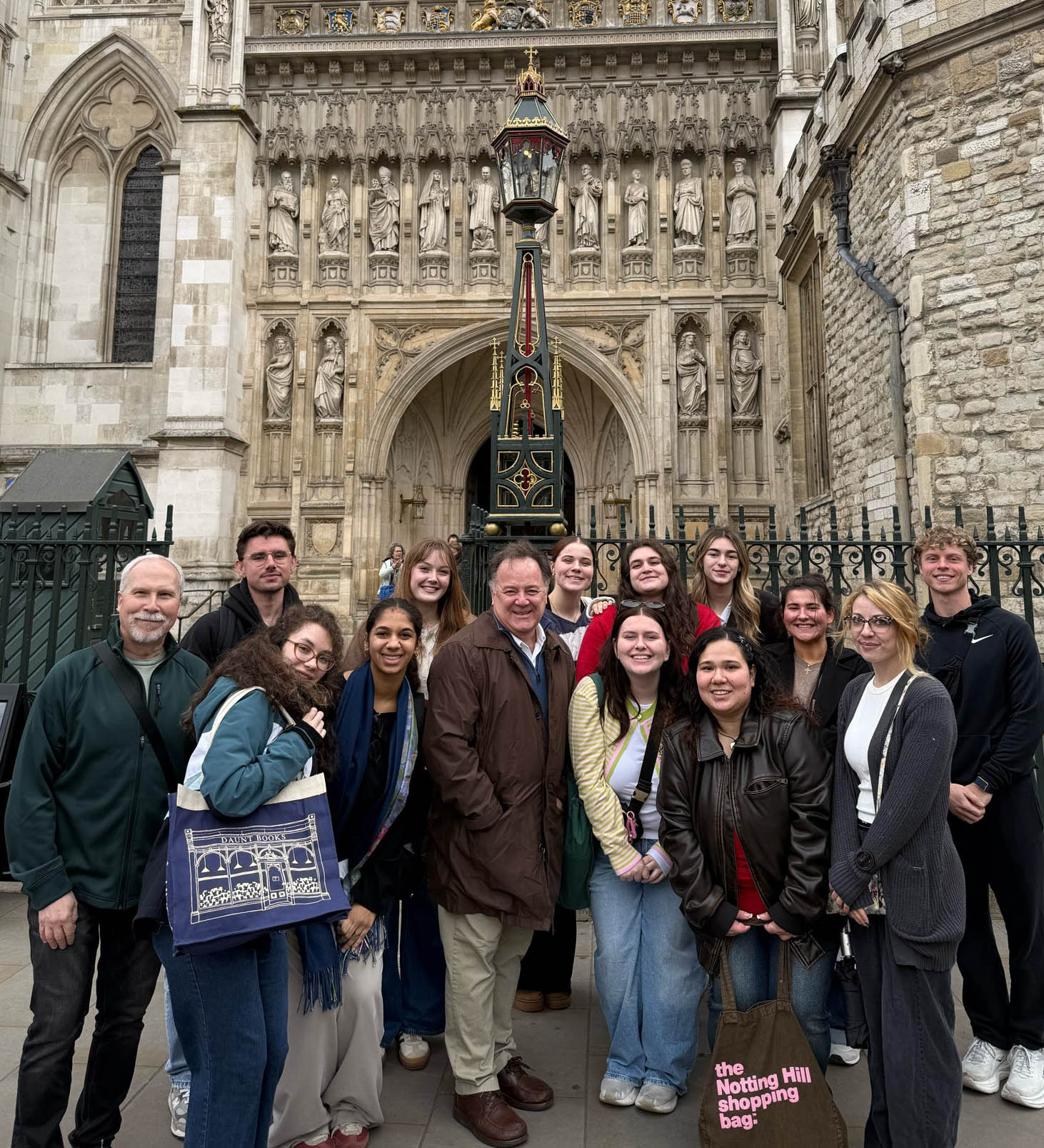Students and Faculty from the Beeghly College of Liberal Arts, Social Sciences, and Education Psychology in Historical and Cultural Context: Study Abroad in London course pose in fornt of Westminster Abby