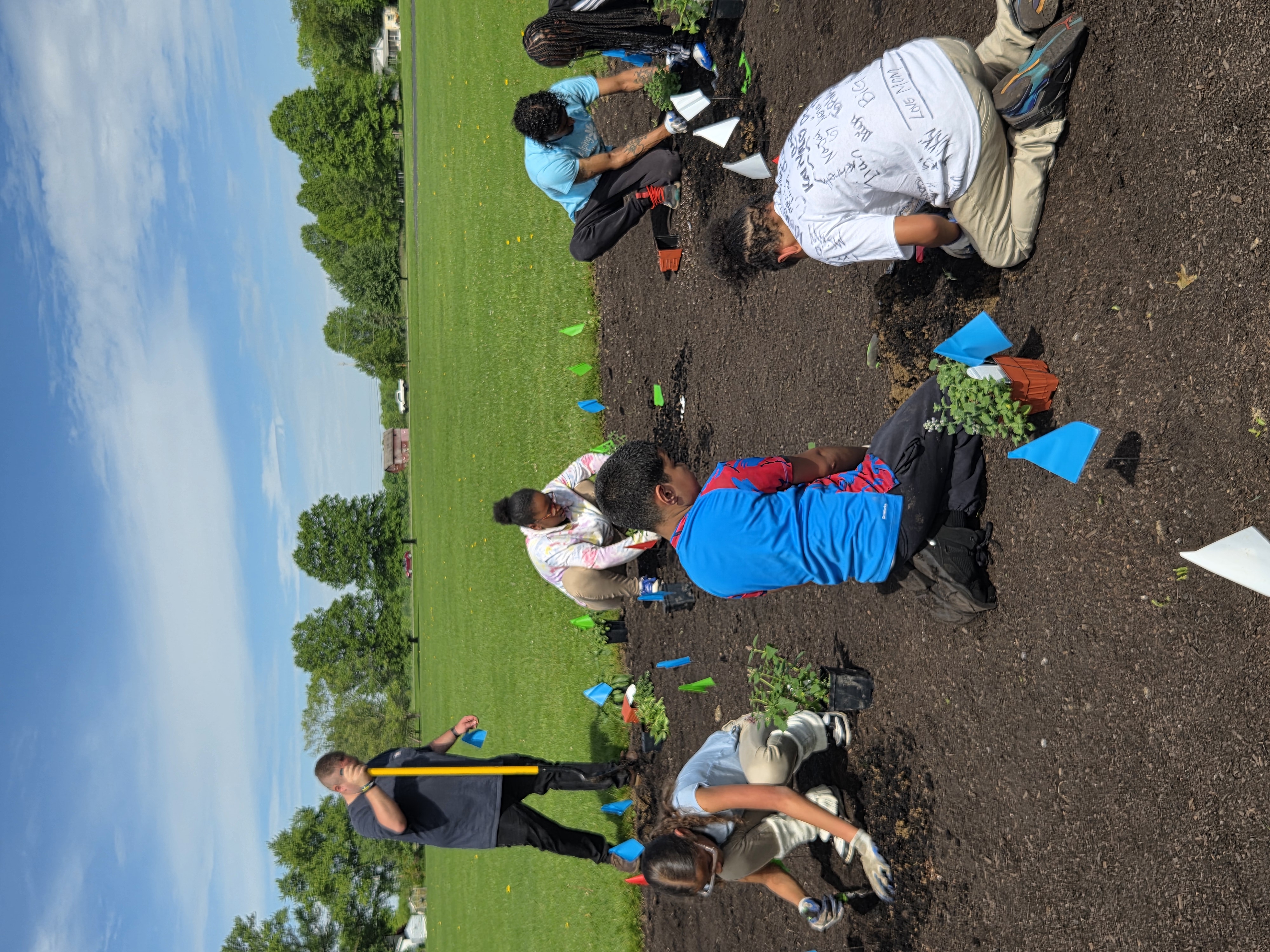 Students from South Side Academy work on the pollinator garden