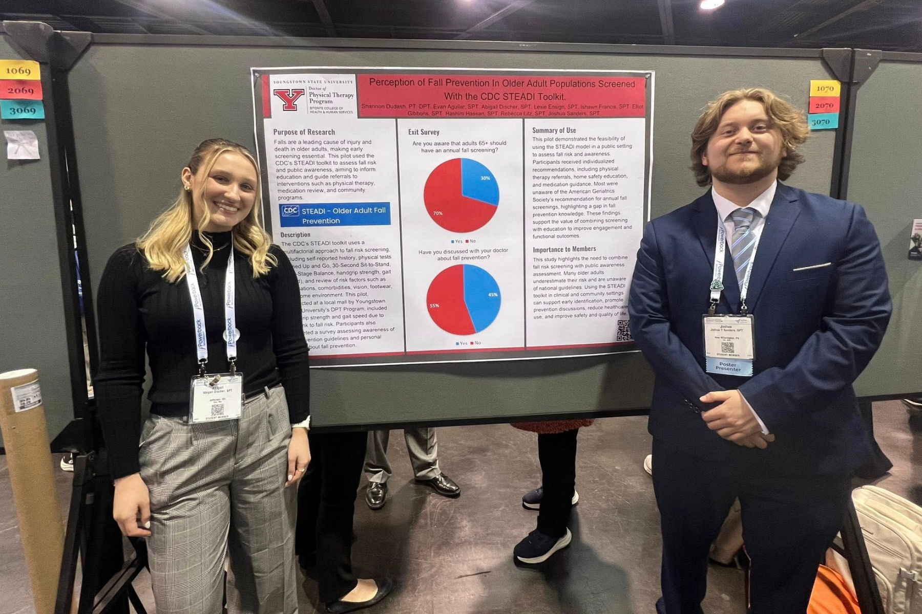 Abby Discher and Josh Sanders posing with their research poster
