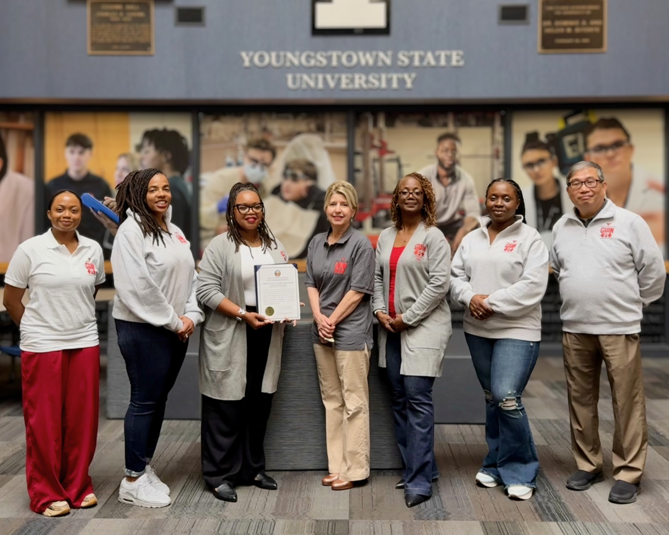 Guin Fit staff pose with the certificate from the city of Youngstown