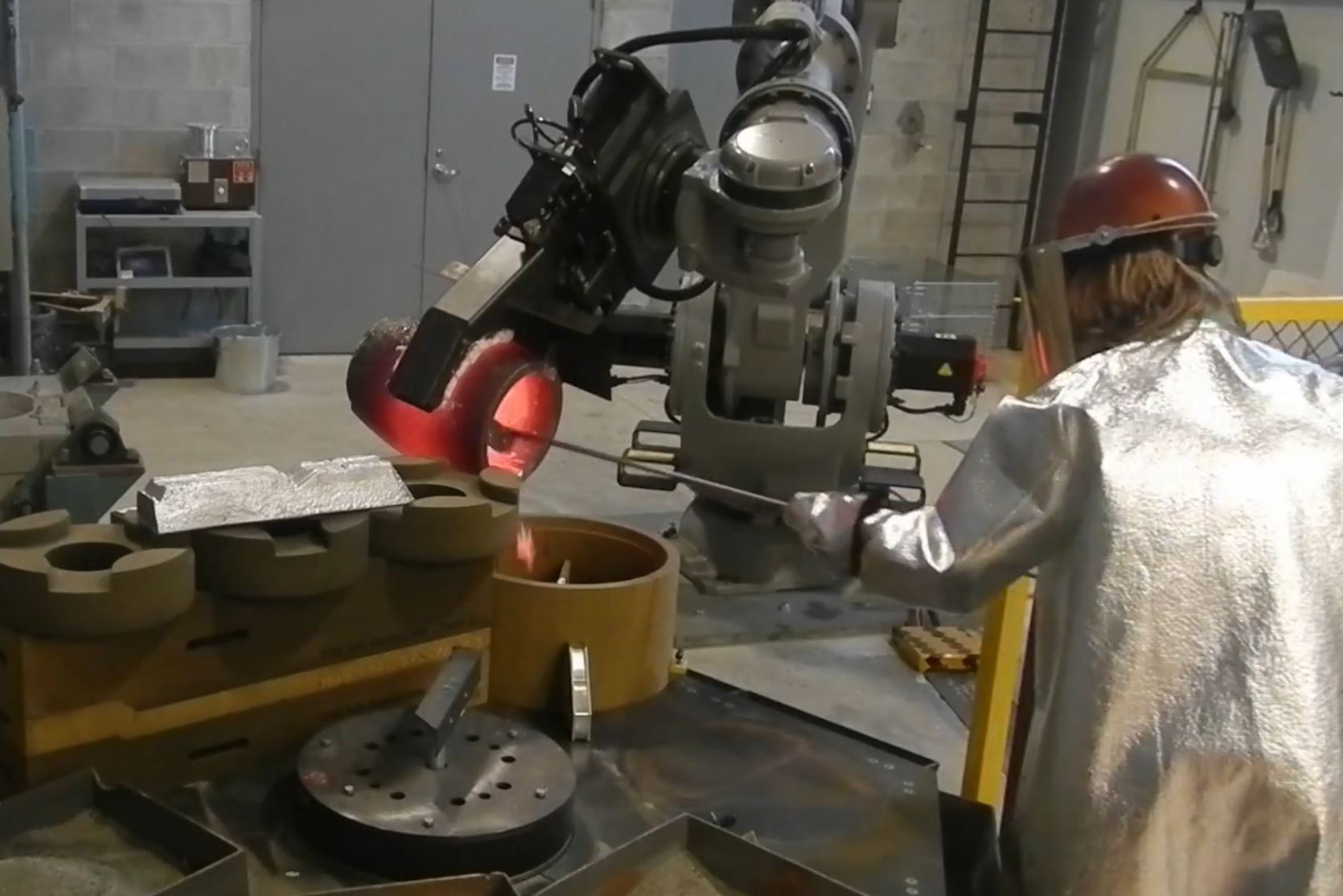 A student in YSU’s mechanical engineering technology program cleaning the crucible used in metalcasting