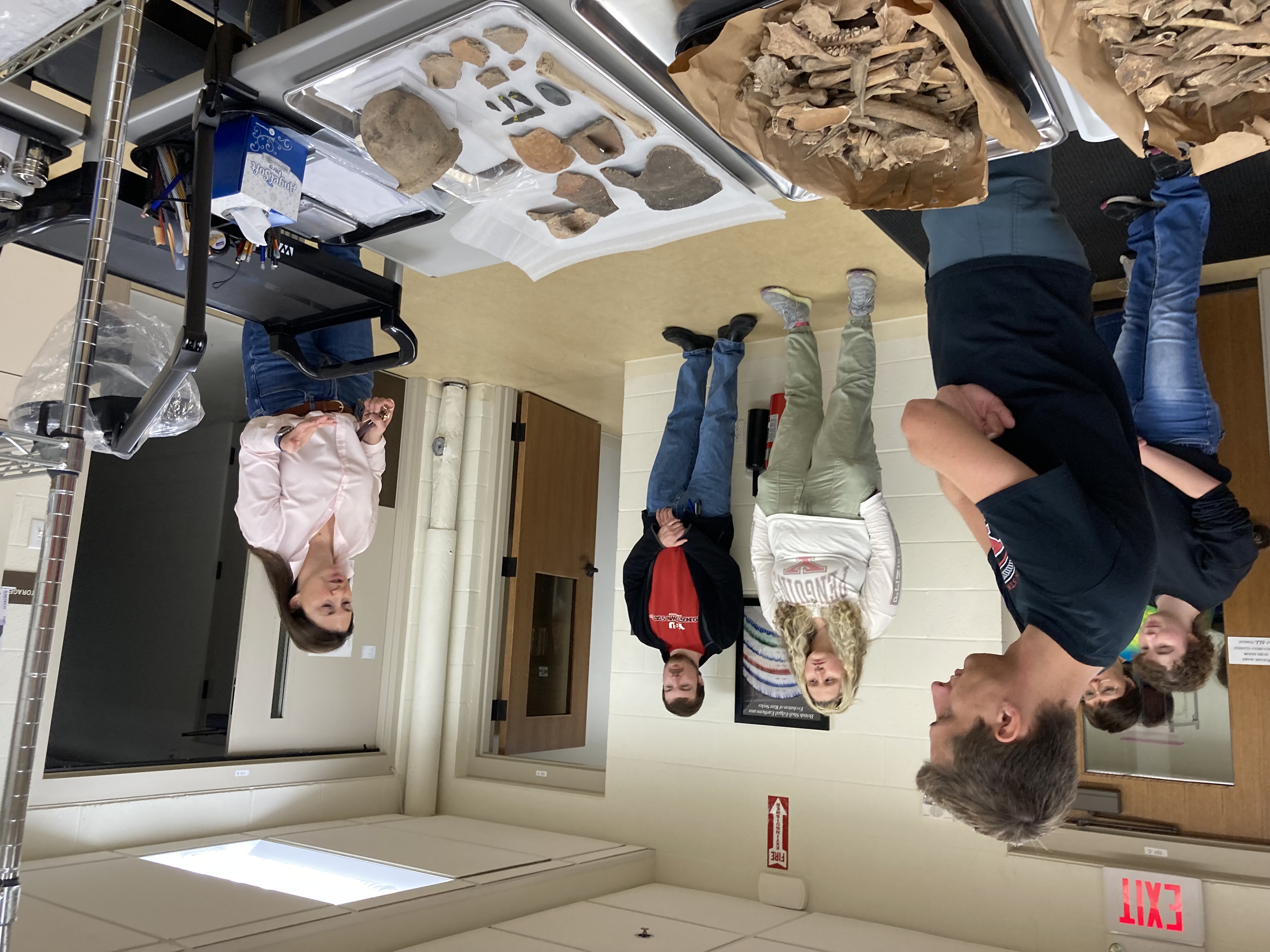 Darcy McTigue, Kelly Baer, Michael Vinkler, Delani Berkson and Mitch McTigue listen as Archaeological Curator Olivia Jones, explains the curation process.