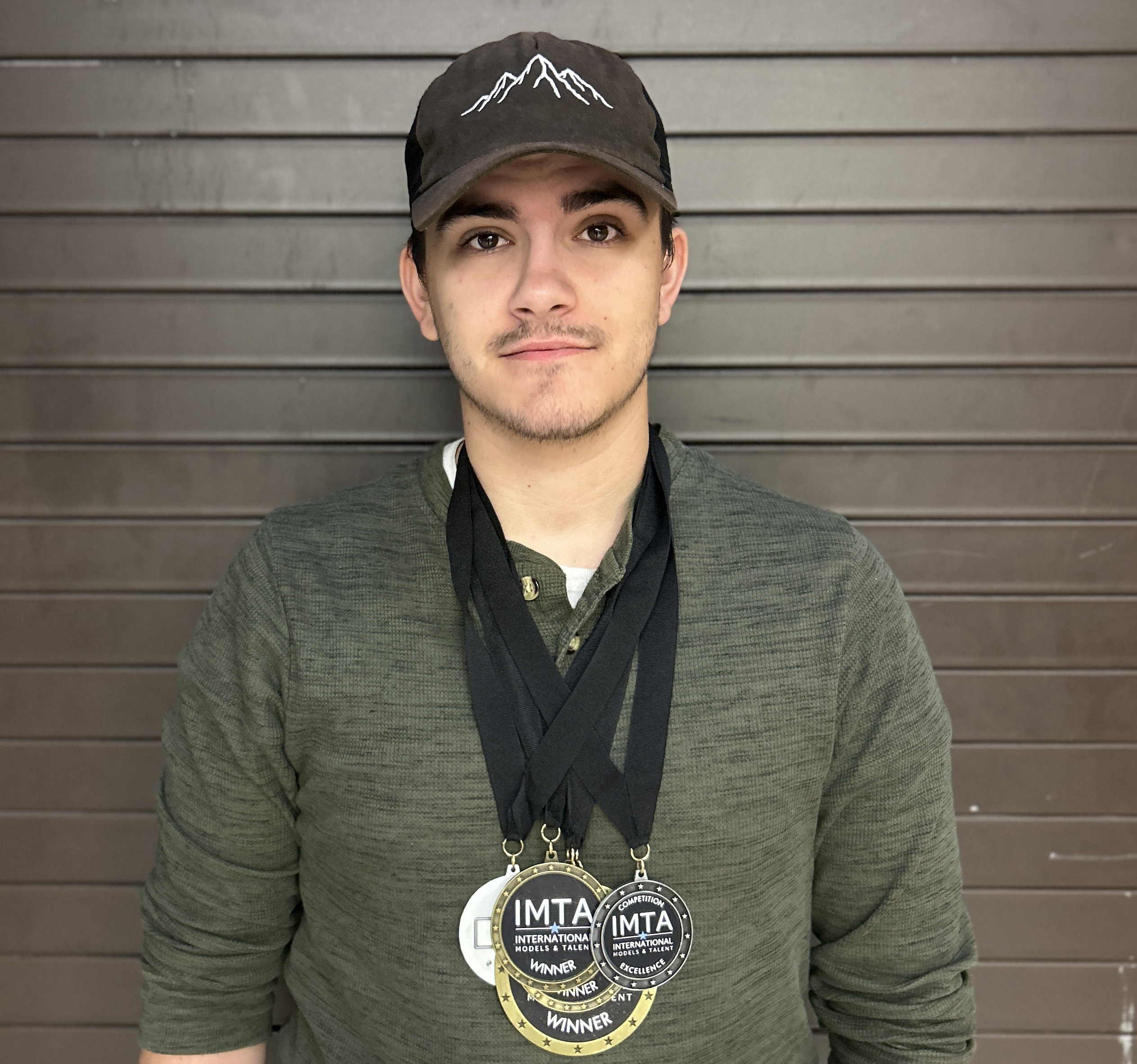 Gunnar Carwile with his medals from the International Model and Talent Association’s annual summer competition
