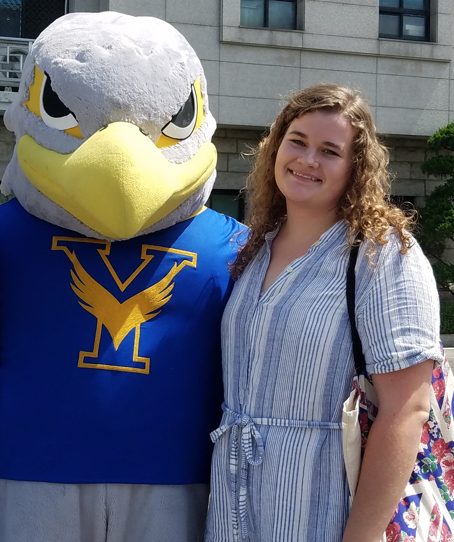 Emily Henline posing with a mascot