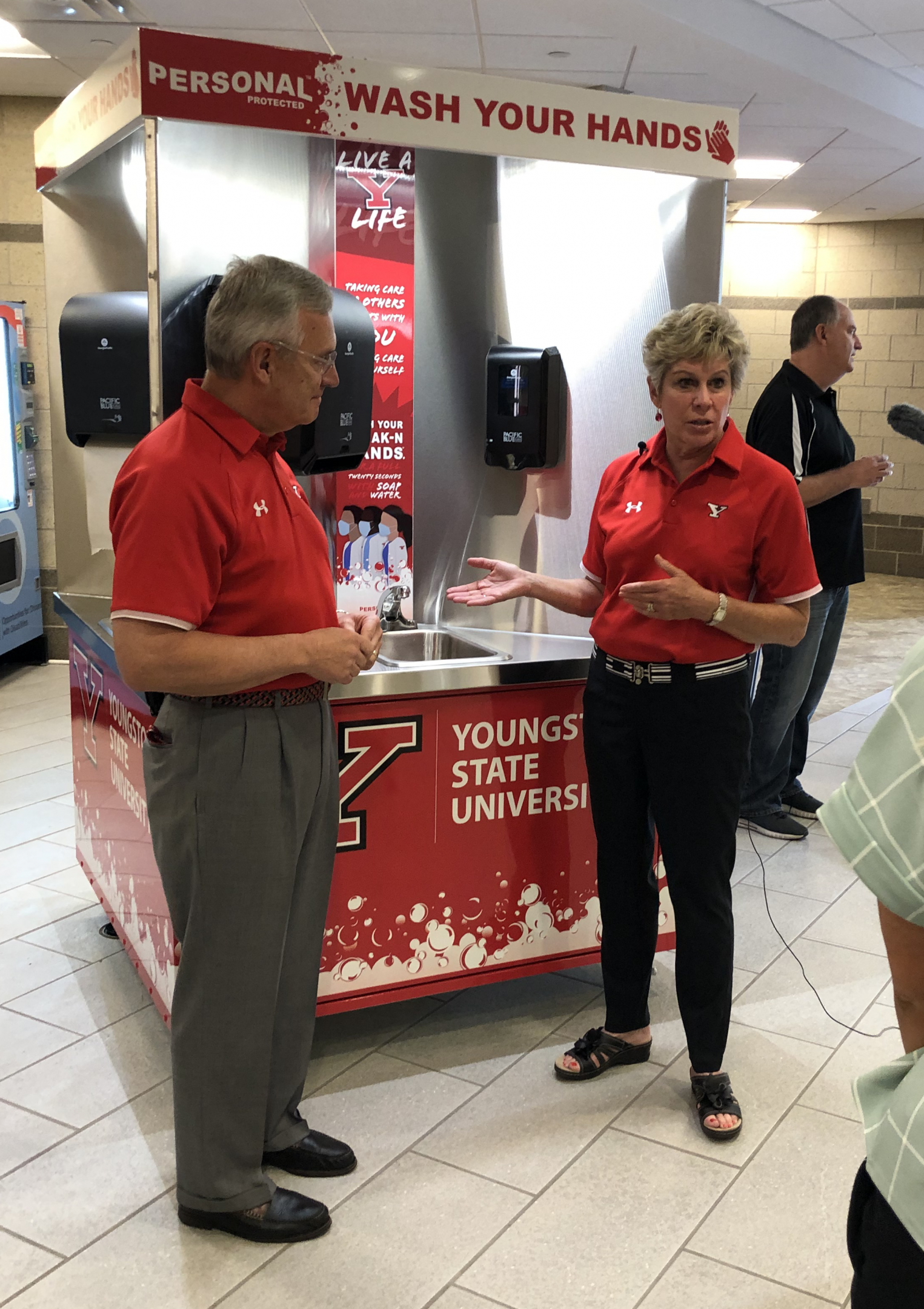 President and Mrs. Ellen Tressel demonstrating the new handwashing stations on campus