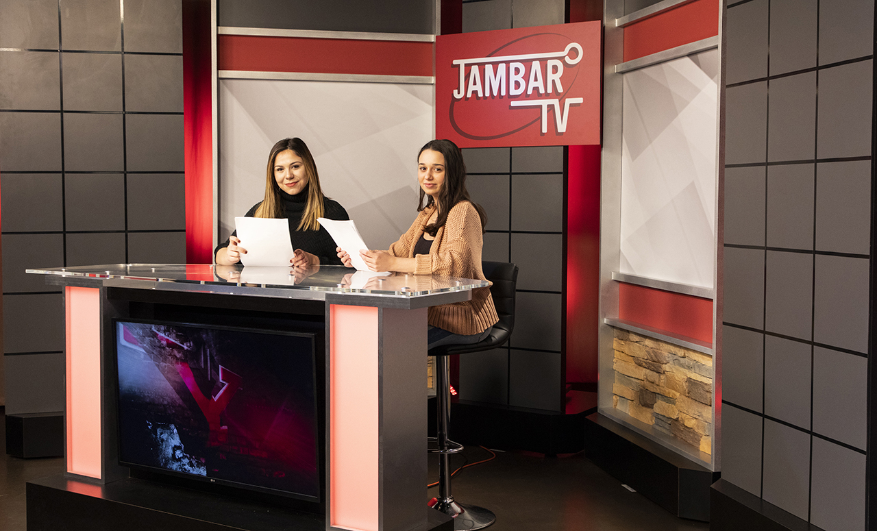 Jambar TV set with two students