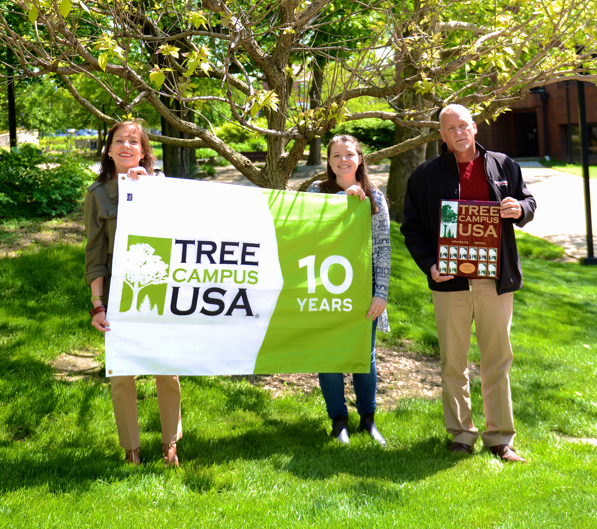 Celebrating YSU’s 10th year as a Tree Campus USA are members of the Campus Beautification Initiative Working Group, from the left, Catherine Cala, Madeline Rosile (student member) and David Ewing, standing in front of a Golden Catalpa Catalpa bignonioides ‘Aurea’, a donor tree representing one of the 17 new species on campus.