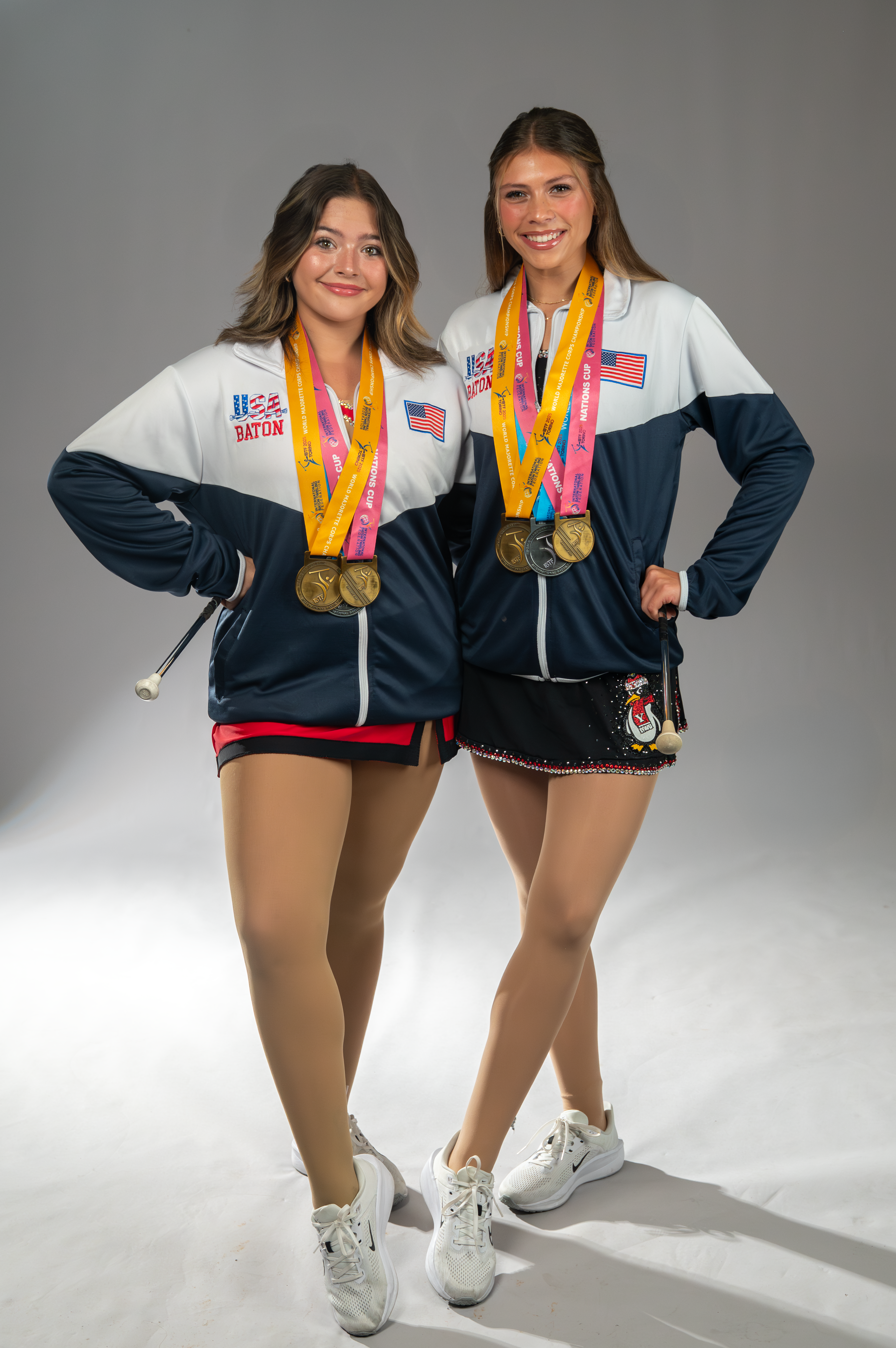 YSU feature twirlers Madeline Huff and Kaylynn Egan pose with their two gold and one silver medals from the International Baton Twirling Federation World Championships in Turin, Italy