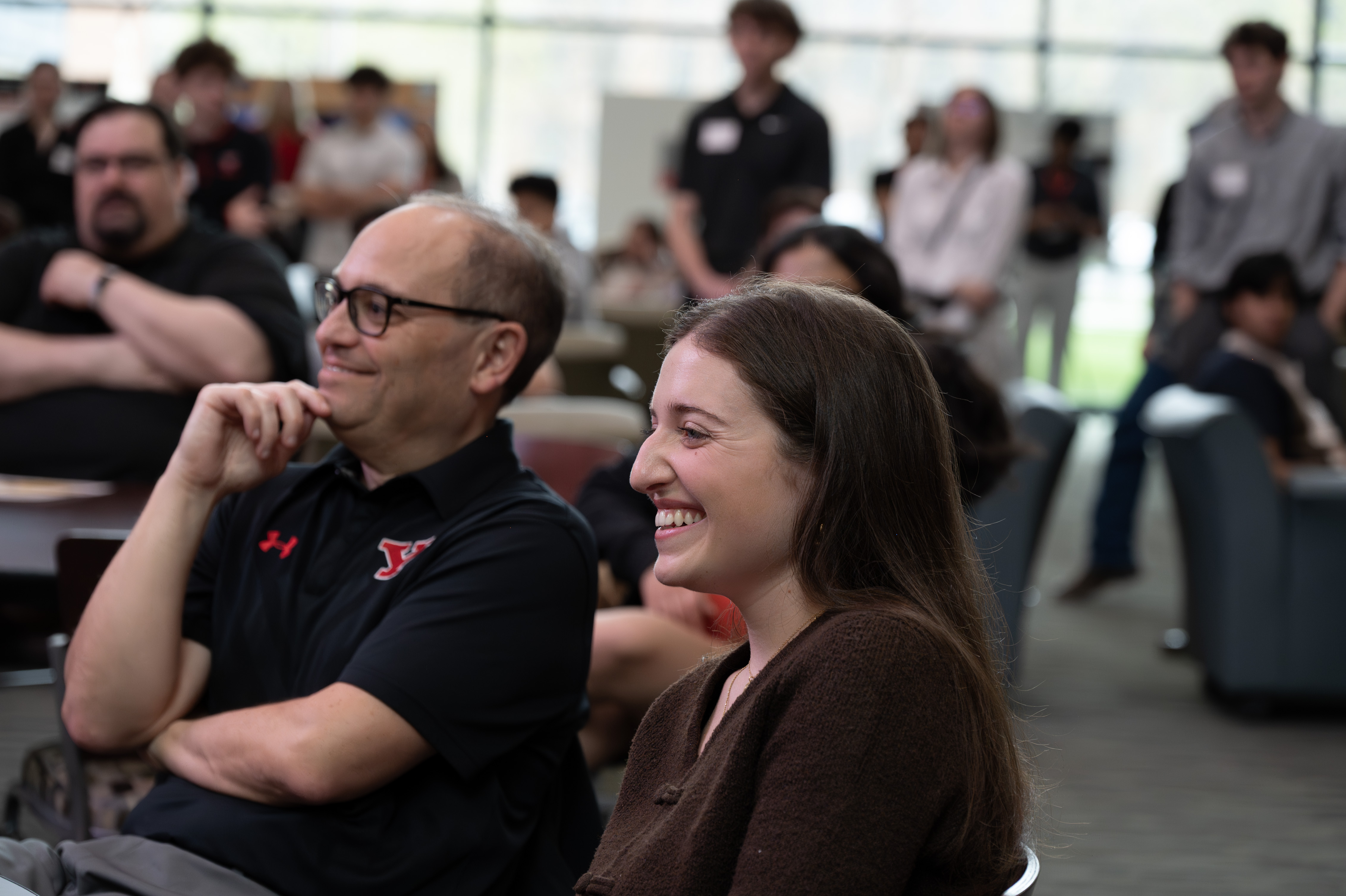 Anna Morgione and her dad, Greg smiling at the Community Engagement Symposium