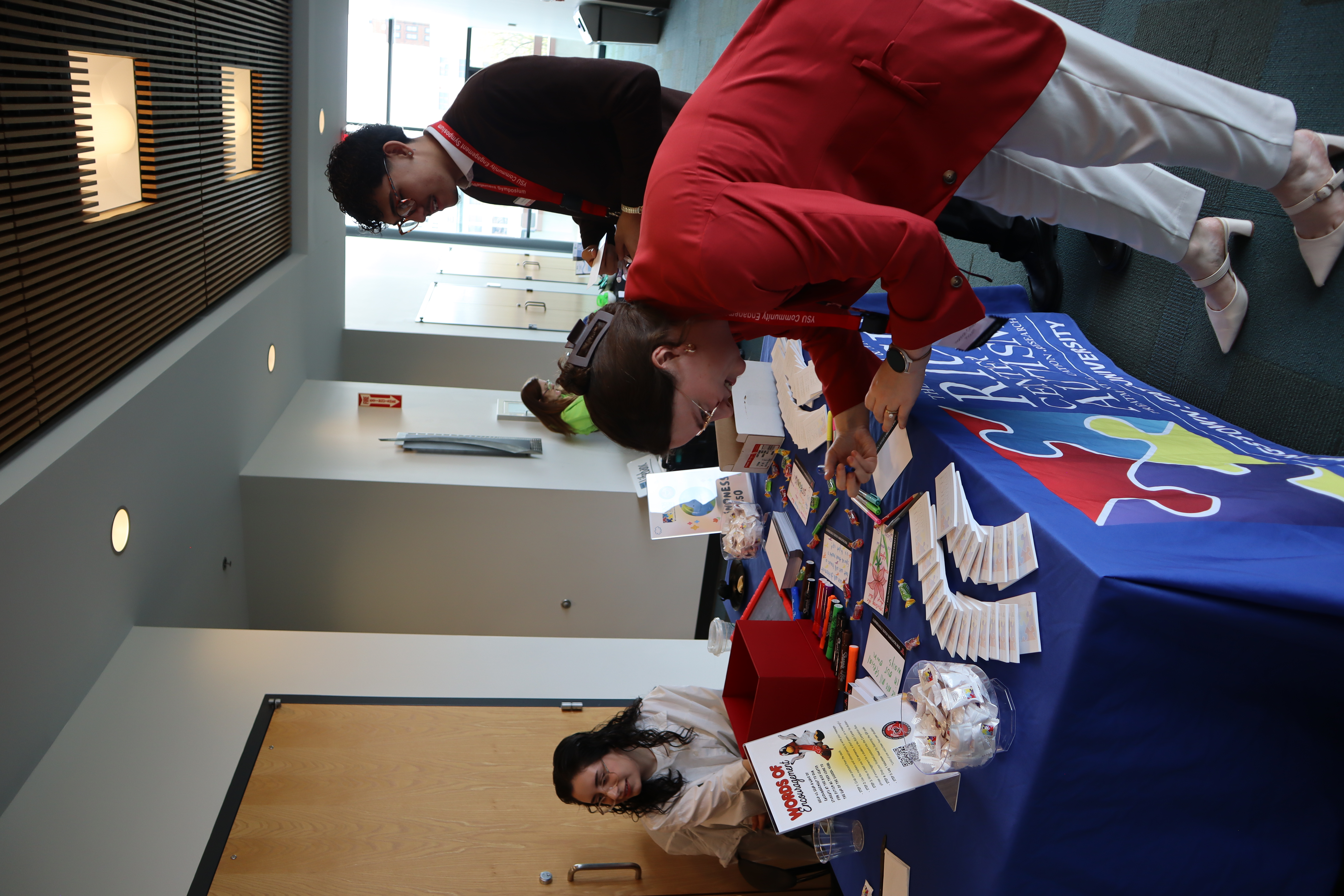Symposium participants engage in a hands-on community activity, writing encouraging cards to students at the Rich Center for Autism.