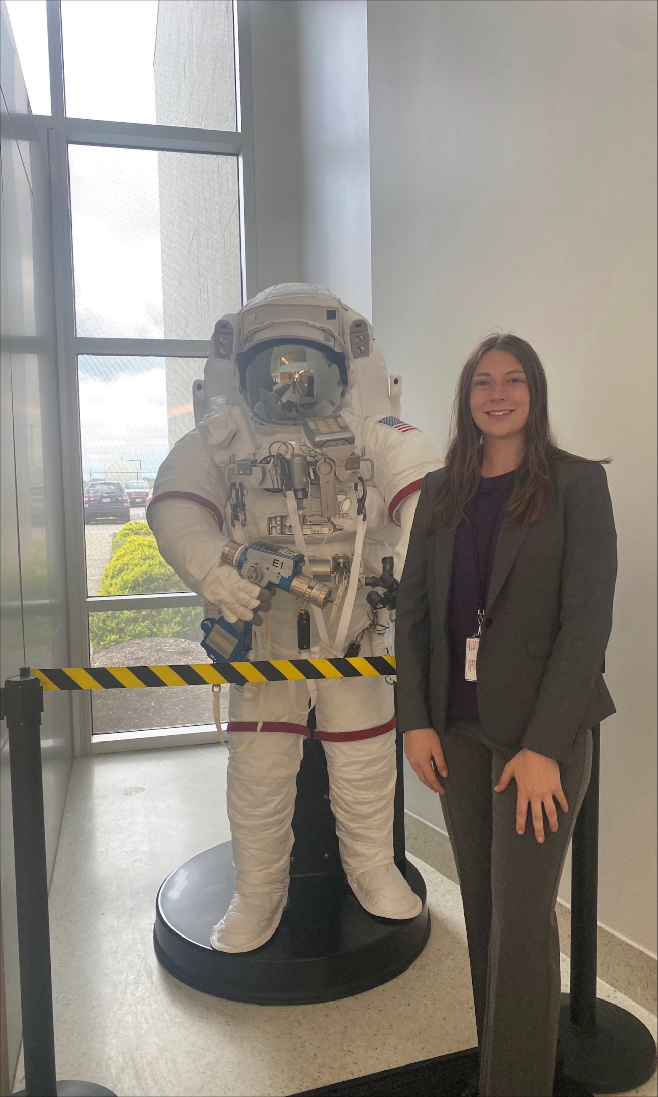 Trinity Miller posing with a NASA space suit