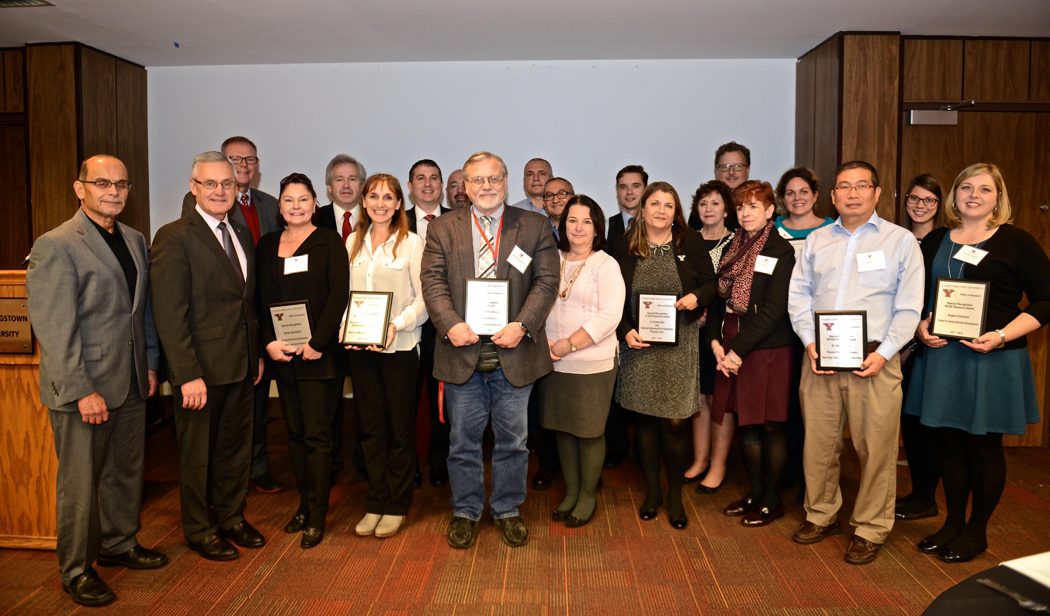 Provost Joe Mosca and President Jim Tressel with the recipients of research awards from the YSU Office of Research.