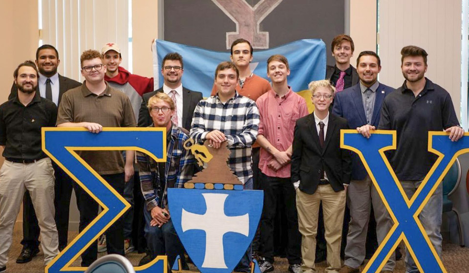 Sigma Chi members and wooden letters