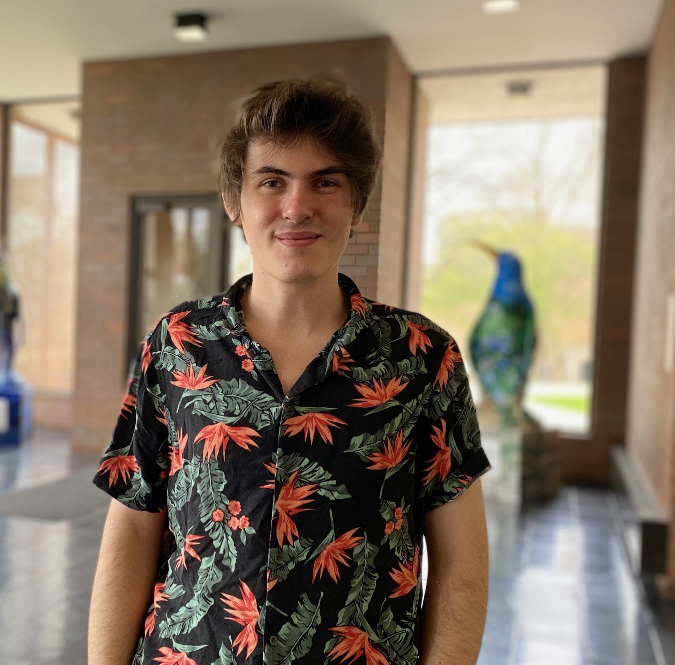 Cole Kistler posing in the lobby of Tod Hall