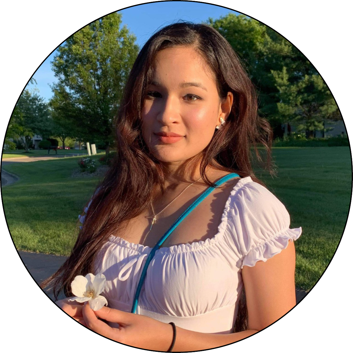 Photo of Shreeya Manandhar outside holding a flower.