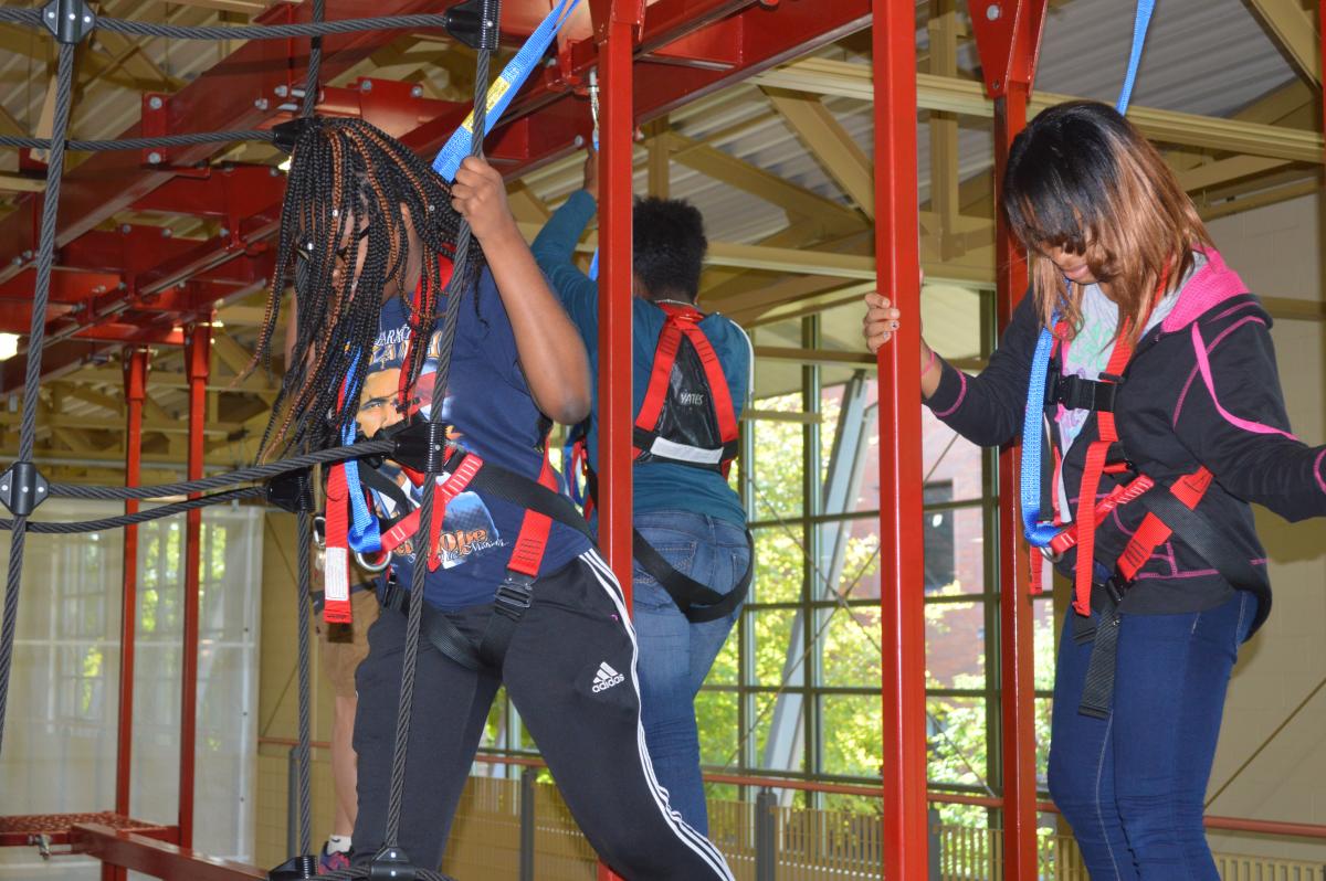students using elevated wlakway during adventure rec activity
