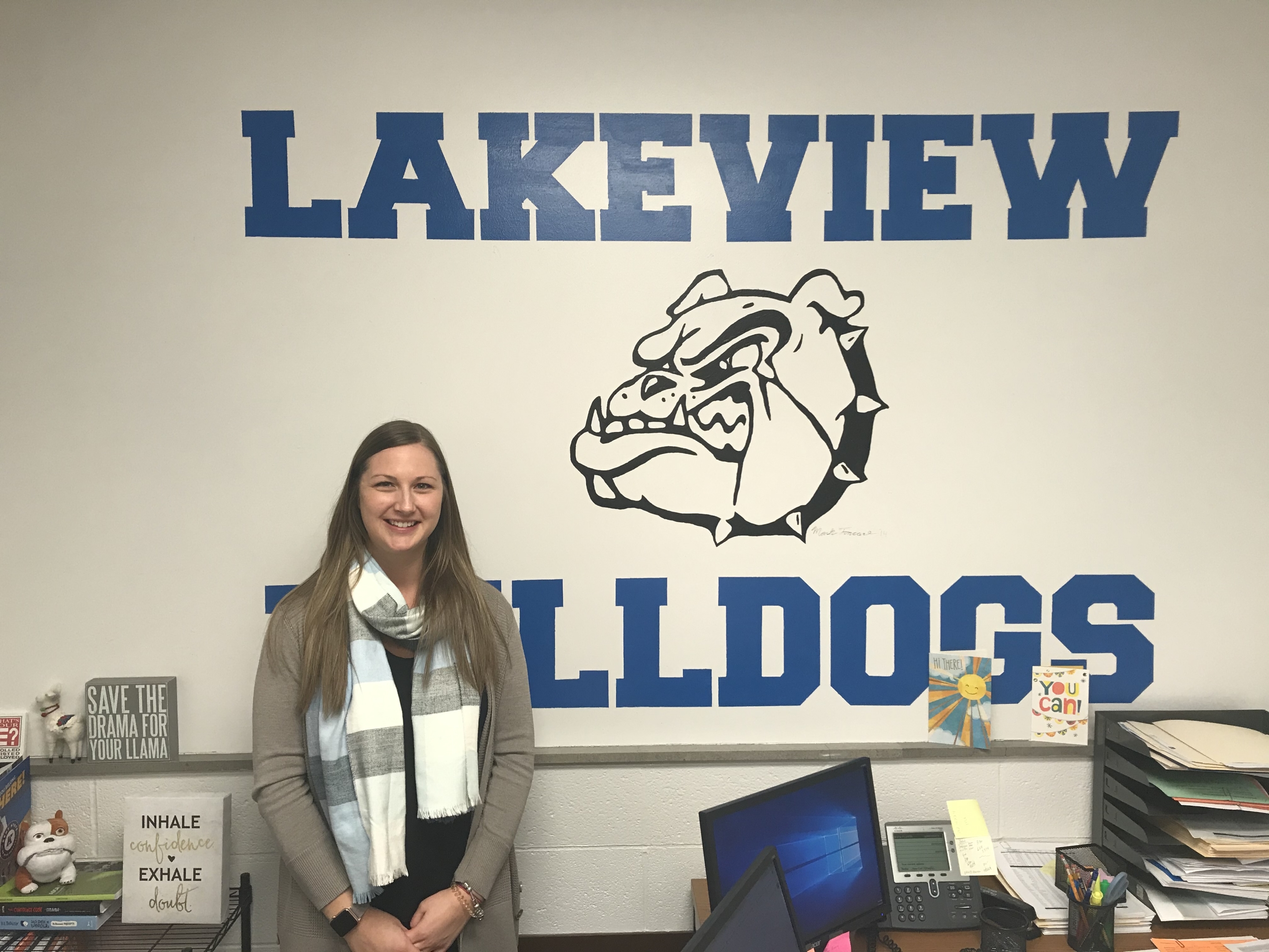 Lakeview High School Coordinator smiling in front of a Lakeview Bulldogs mural