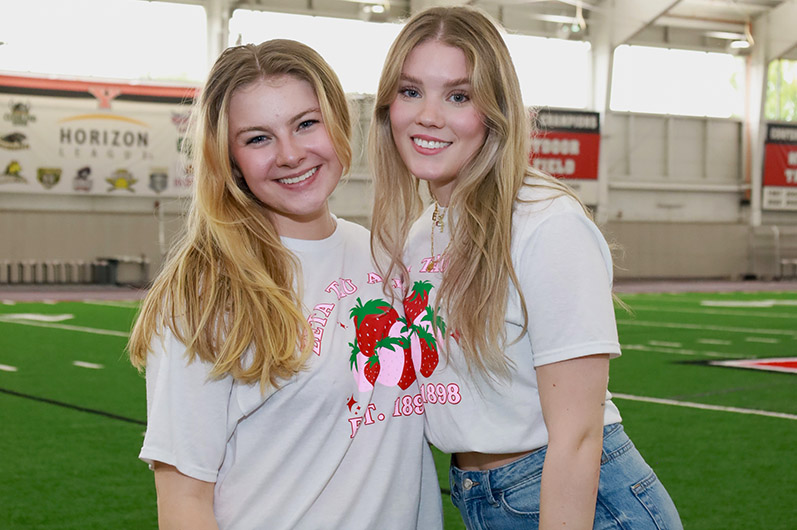 5 Girls posing with Trophies and AXID logo