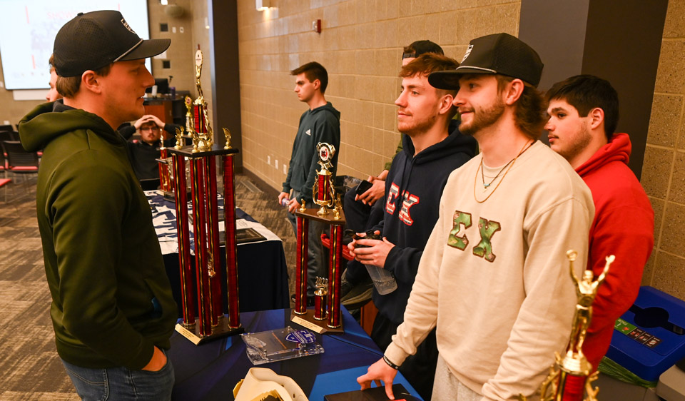 Sigma Chi members talking with guest
