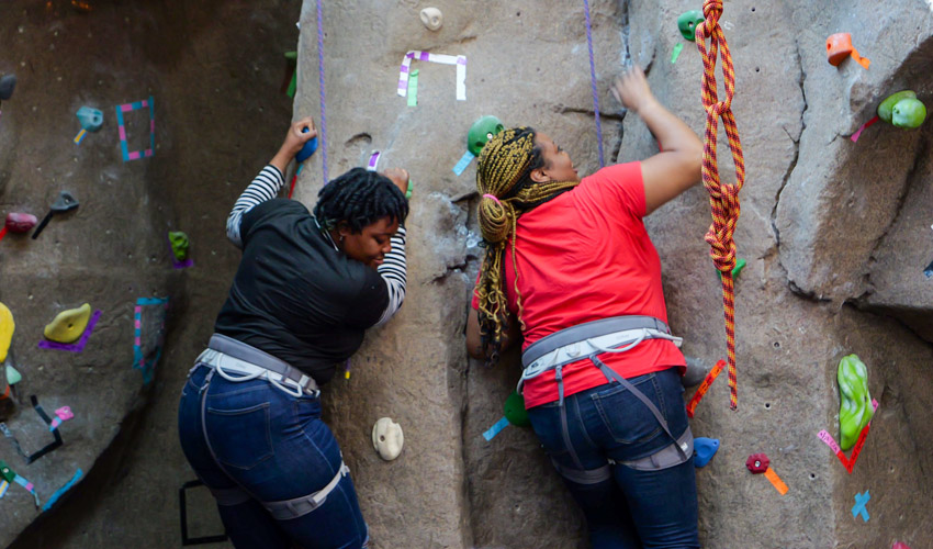 2 girls on rock climbing wall