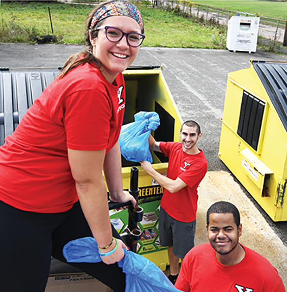 YSU students Madyson Hornbeckand Shelton Smith work with Dan Kuzma, manager of YSU Materials Exchange and Recycling