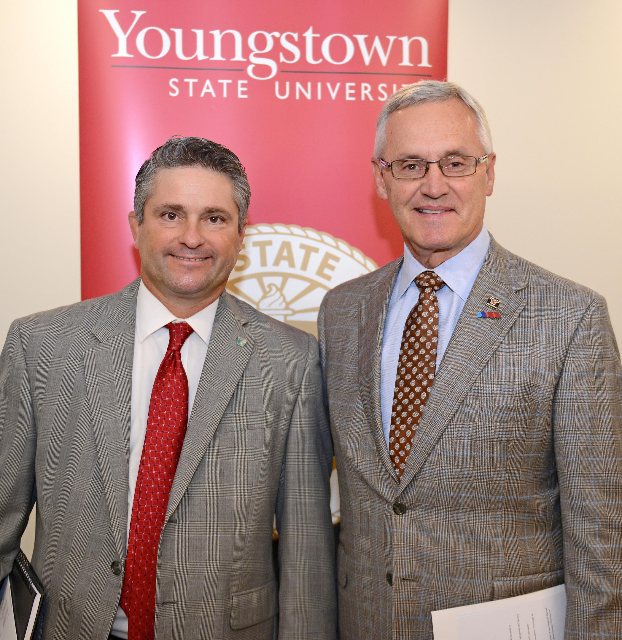Ben Stoffer, left, Medical Mutual regional vice president, Canton, Youngstown and Southeast Region, and YSU President Jim Tressel.