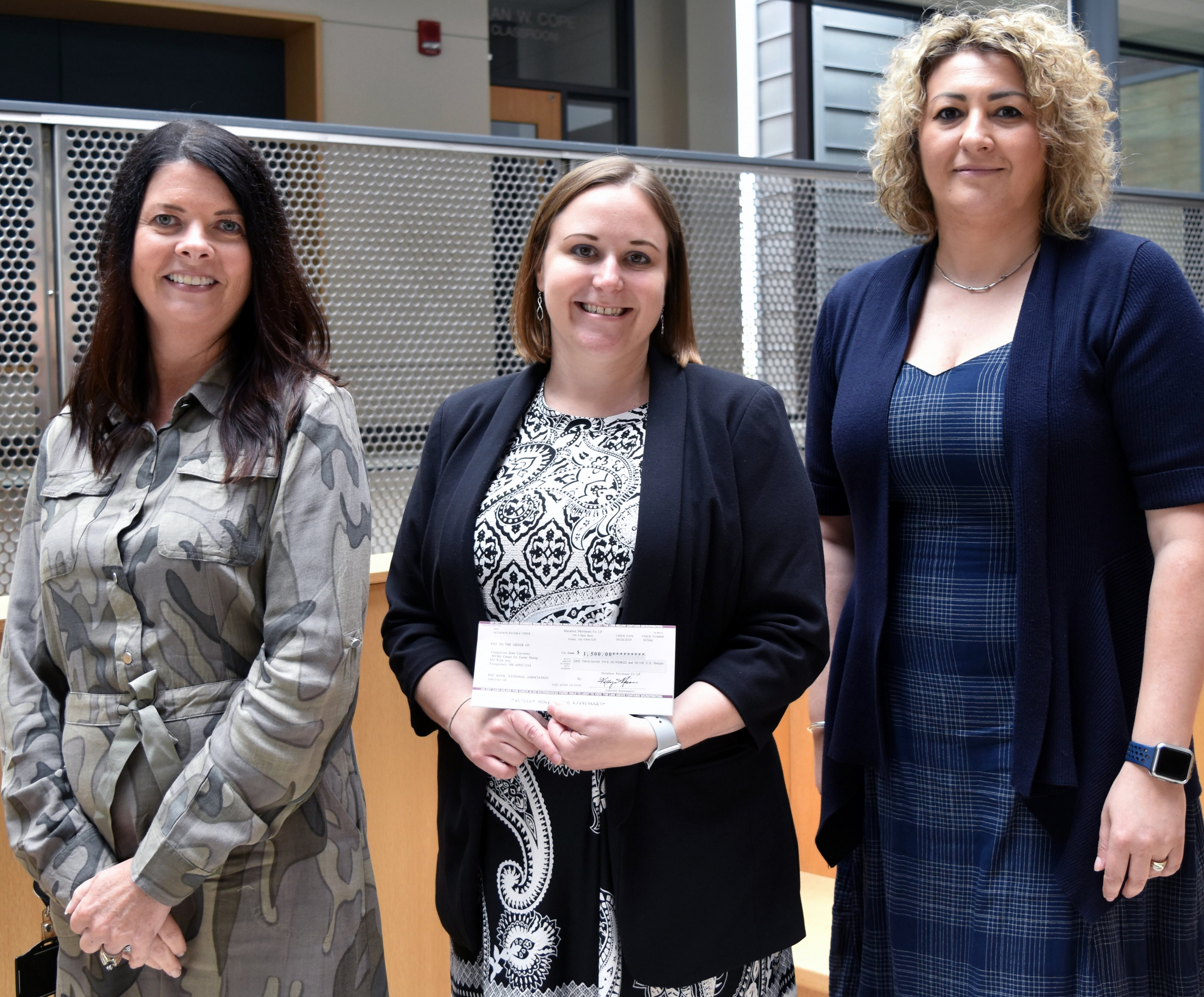 Valerie Luther, region administrative assistant of Speedway, left, and Lejla Sehic, advance human resources advisor at Speedway, right, present a $1,500 check to Christina O’Connell, director of the Center for Career Management in the Williamson College of Business Administration at YSU.