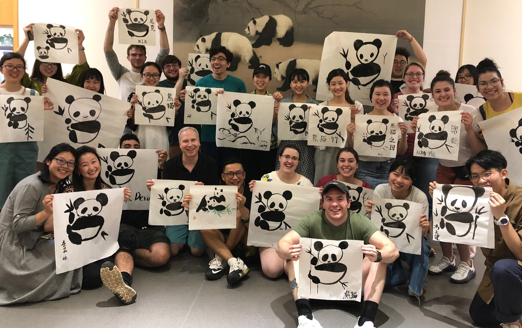 YSU students visiting Chengdu University and painting pandas using the traditional Chinese calligraphy method with students from Sichuan Normal University.