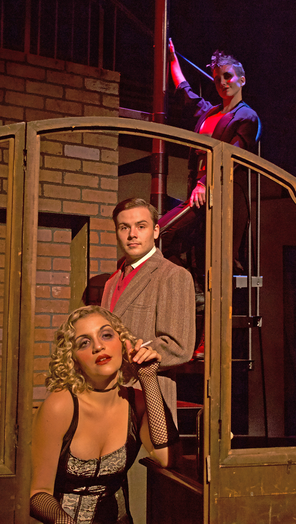 Cast members, bottom to top, AnnMarie Lowerre as Sally Bowles, Nathanael Montgomery as Cliff Bradshaw and Rosie Bresson as the Emcee