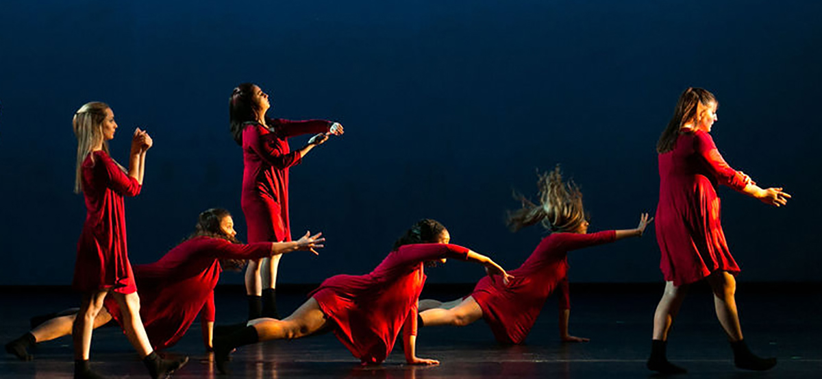 Members of the YSU Dance Ensemble practicing a routine on stage