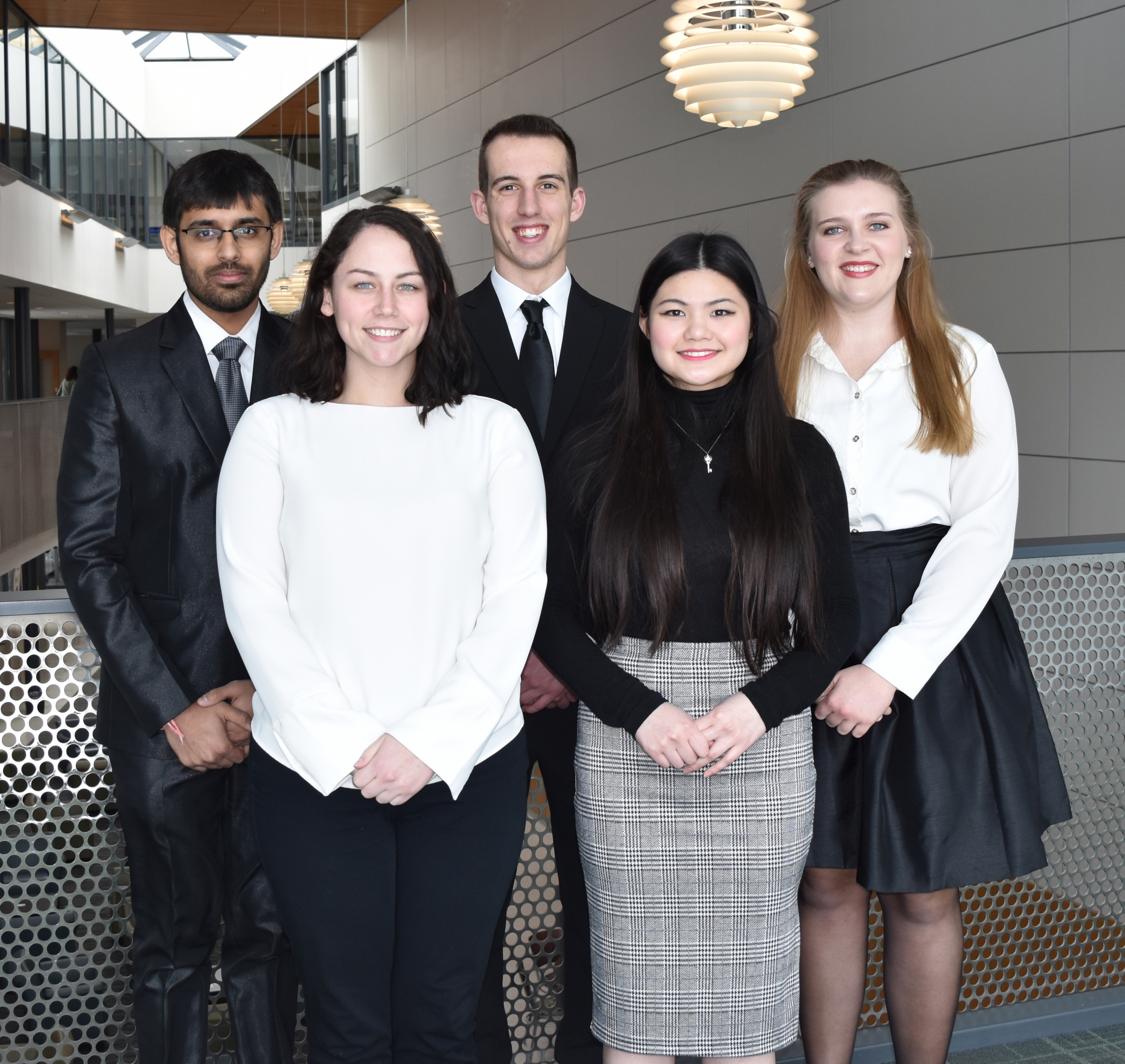 Five business students pose for a photo in the Williamson College of Business Administration